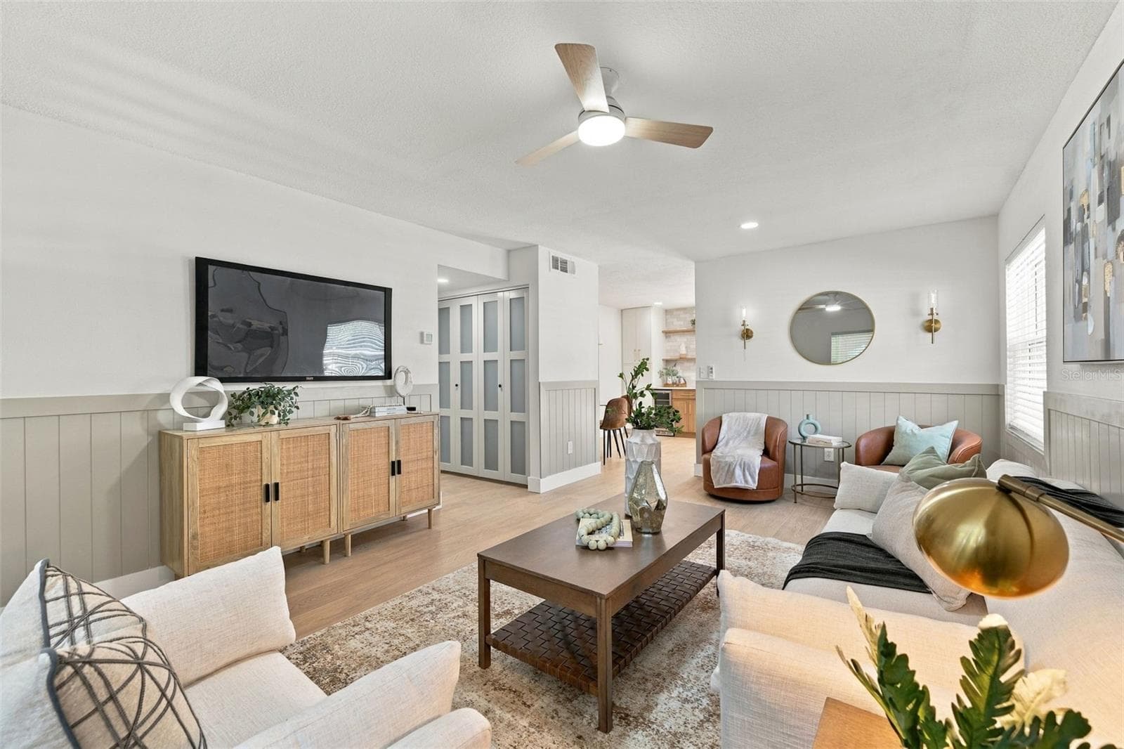 Oversized living room with modern shiplap wainscoting and wall sconces - 1613 GREENWOOD DR, DUNEDIN
