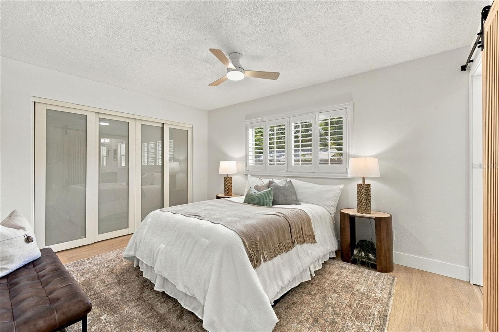 Spacious Primary bedroom with large wall closet and plantation shutters - 1613 GREENWOOD DR, DUNEDIN