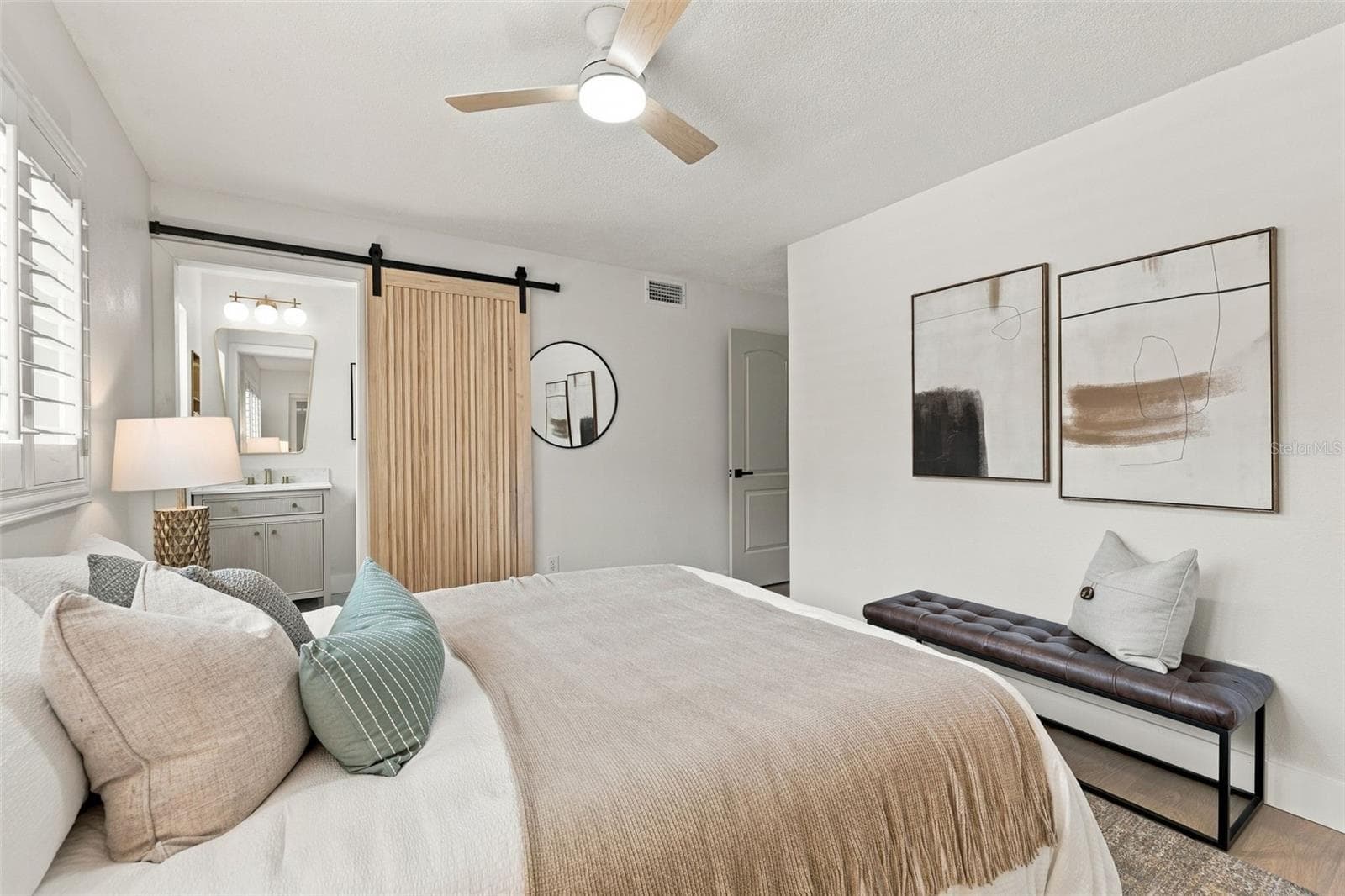 Spacious Primary bedroom with barn door entry to en suite bathroom - 1613 GREENWOOD DR, DUNEDIN