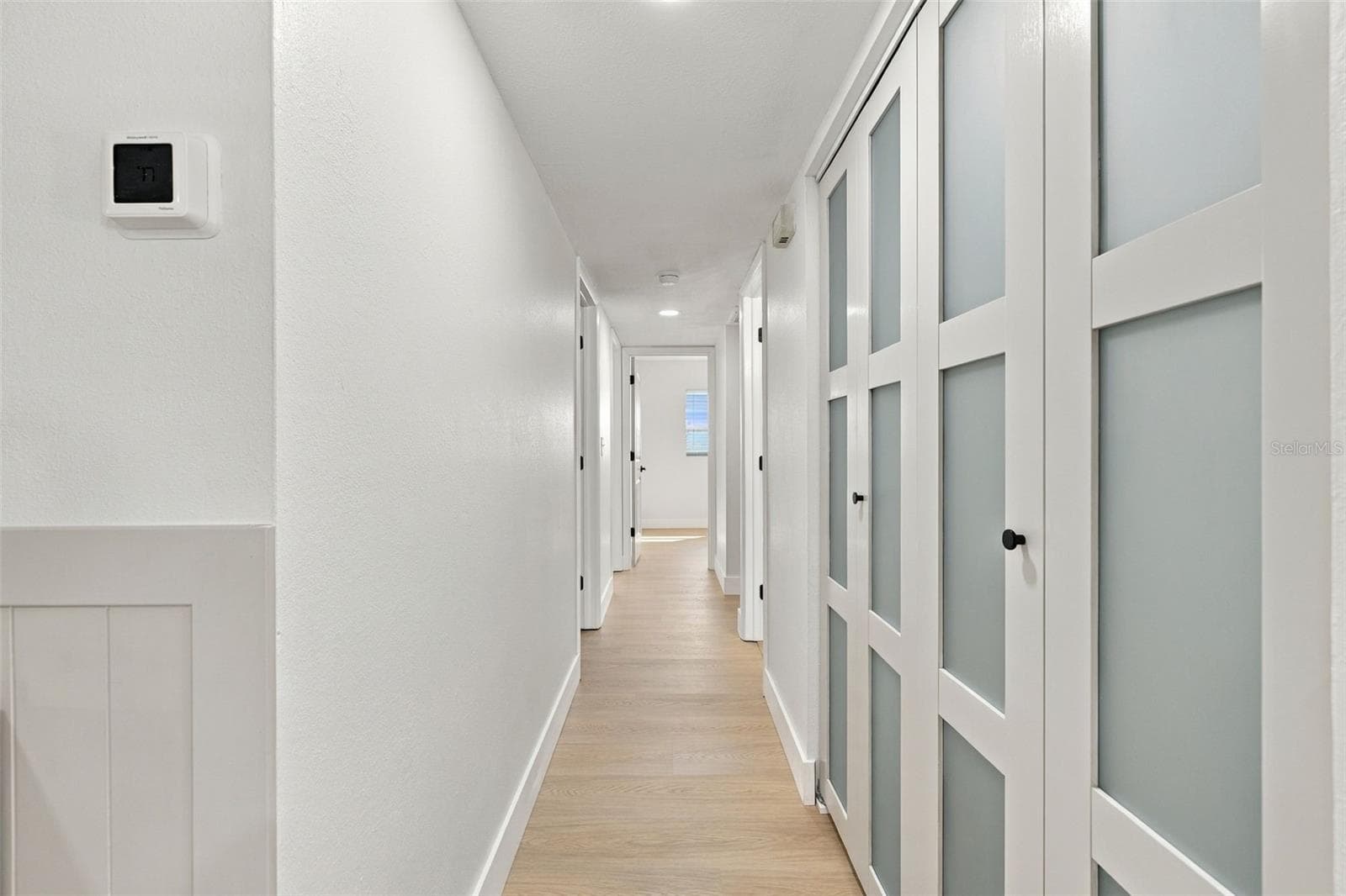 Hallway with frosted doors to interior laundry - 1613 GREENWOOD DR, DUNEDIN