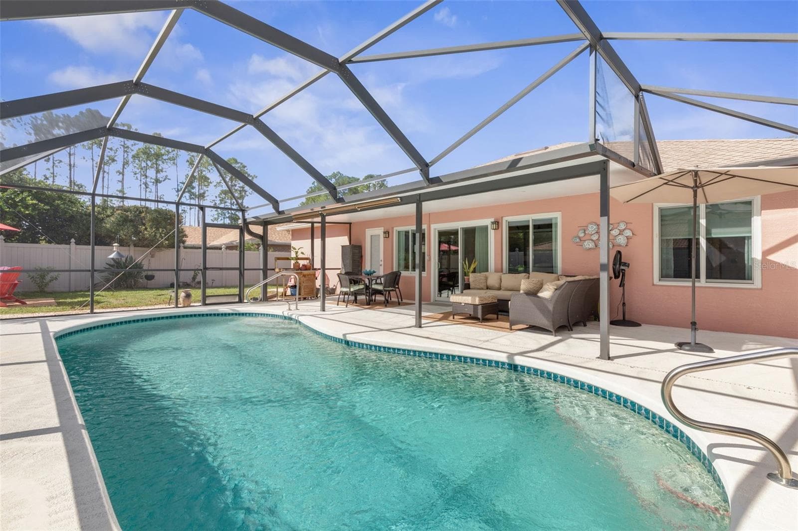 Your own private slice of paradise! Spend sun-filled afternoons floating in the sparkling pool, then unwind in the shade of the screened lanai, where lounging and poolside dining make every day feel like a vacation. - 19 EDGELY LN, PALM COAST