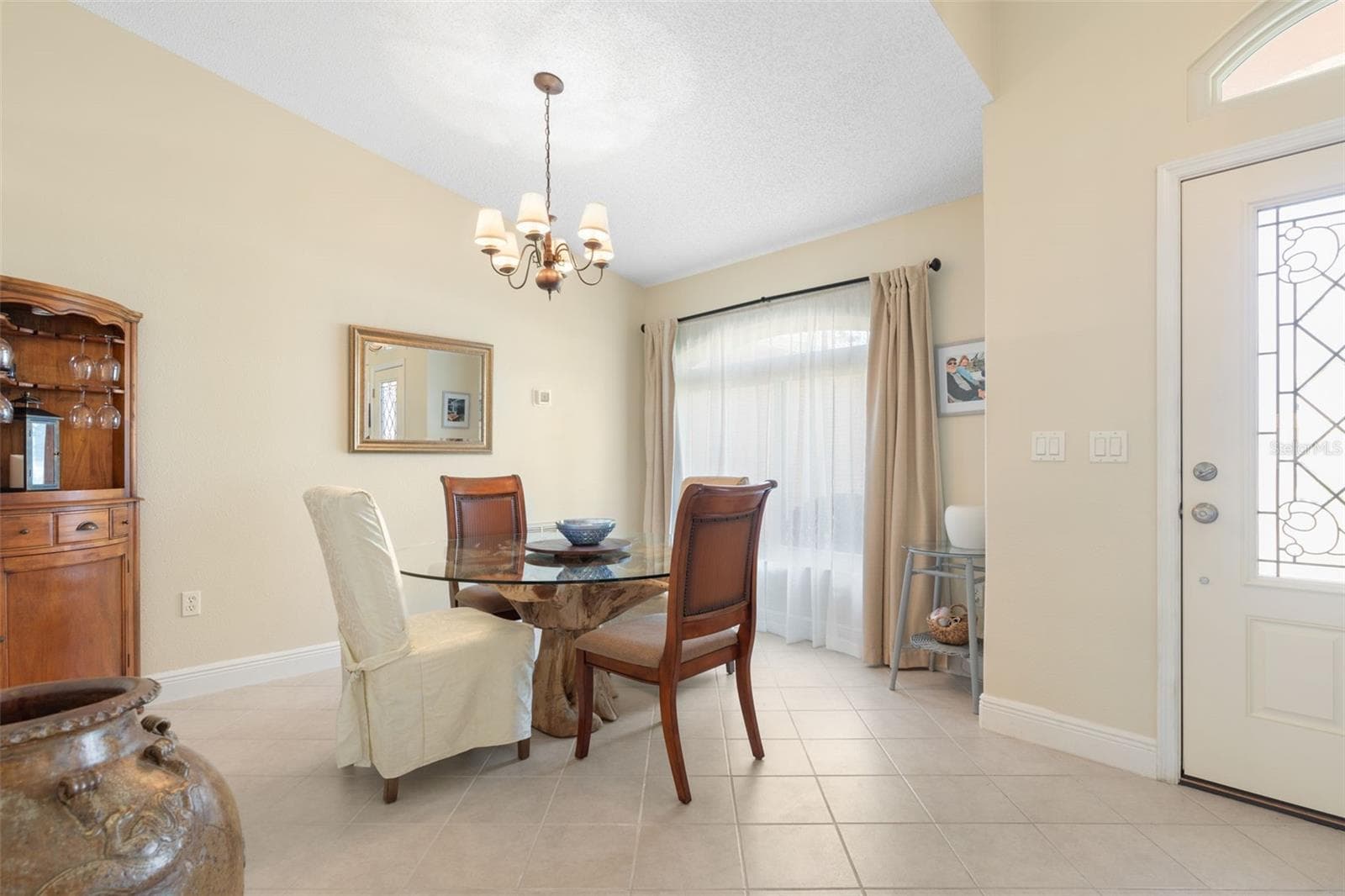 Set the table for memorable dinner parties and holiday celebrations! This charming formal dining room offers an intimate setting, with soft natural light and an elegant chandelier adding a touch of sophistication to every occasion. - 19 EDGELY LN, PALM COAST