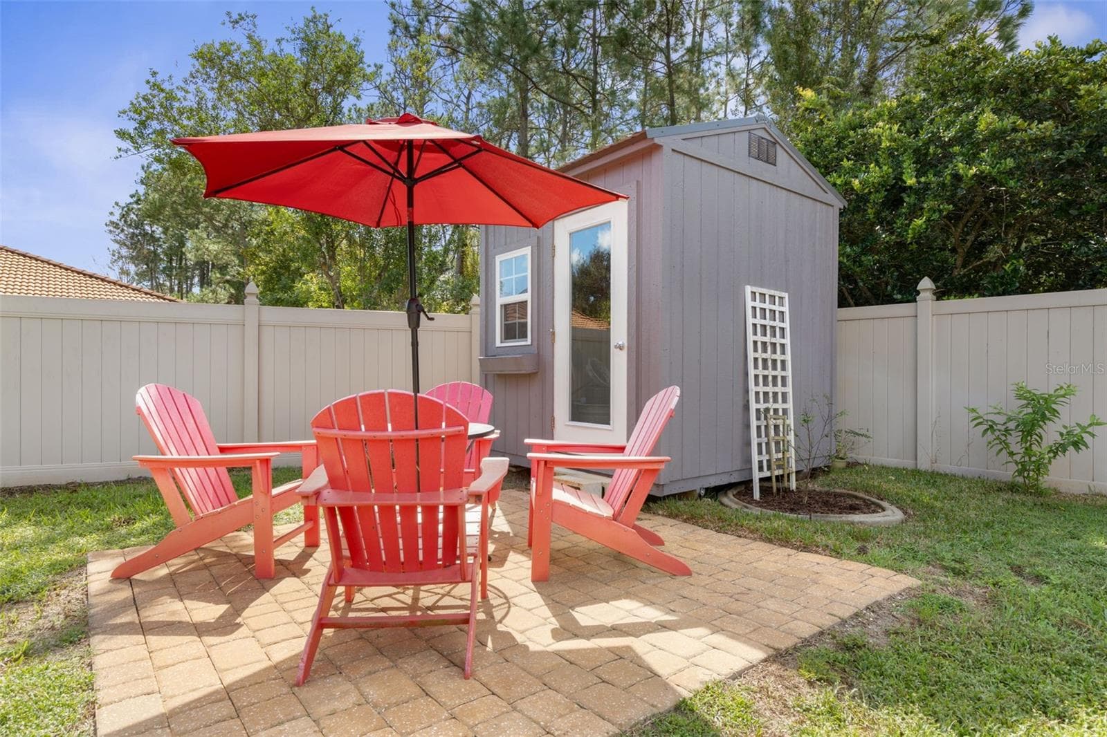 A little getaway right in your own backyard! The charming she shed offers endless possibilities for creativity or hobbies, while the separate paver patio is perfect for morning coffee, afternoon chats - 19 EDGELY LN, PALM COAST