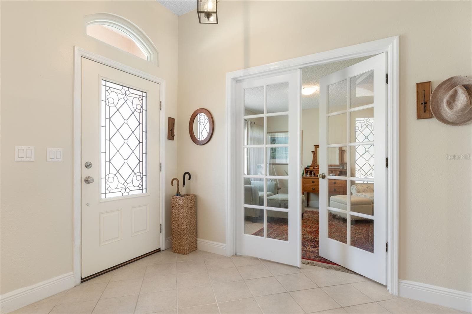 First impressions matter! This lovely foyer features a decorative glass entry door, elegant transom window, and French doors that offer a peek into the adjoining den/office, setting a gracious tone from the moment you arrive - 19 EDGELY LN, PALM COAST