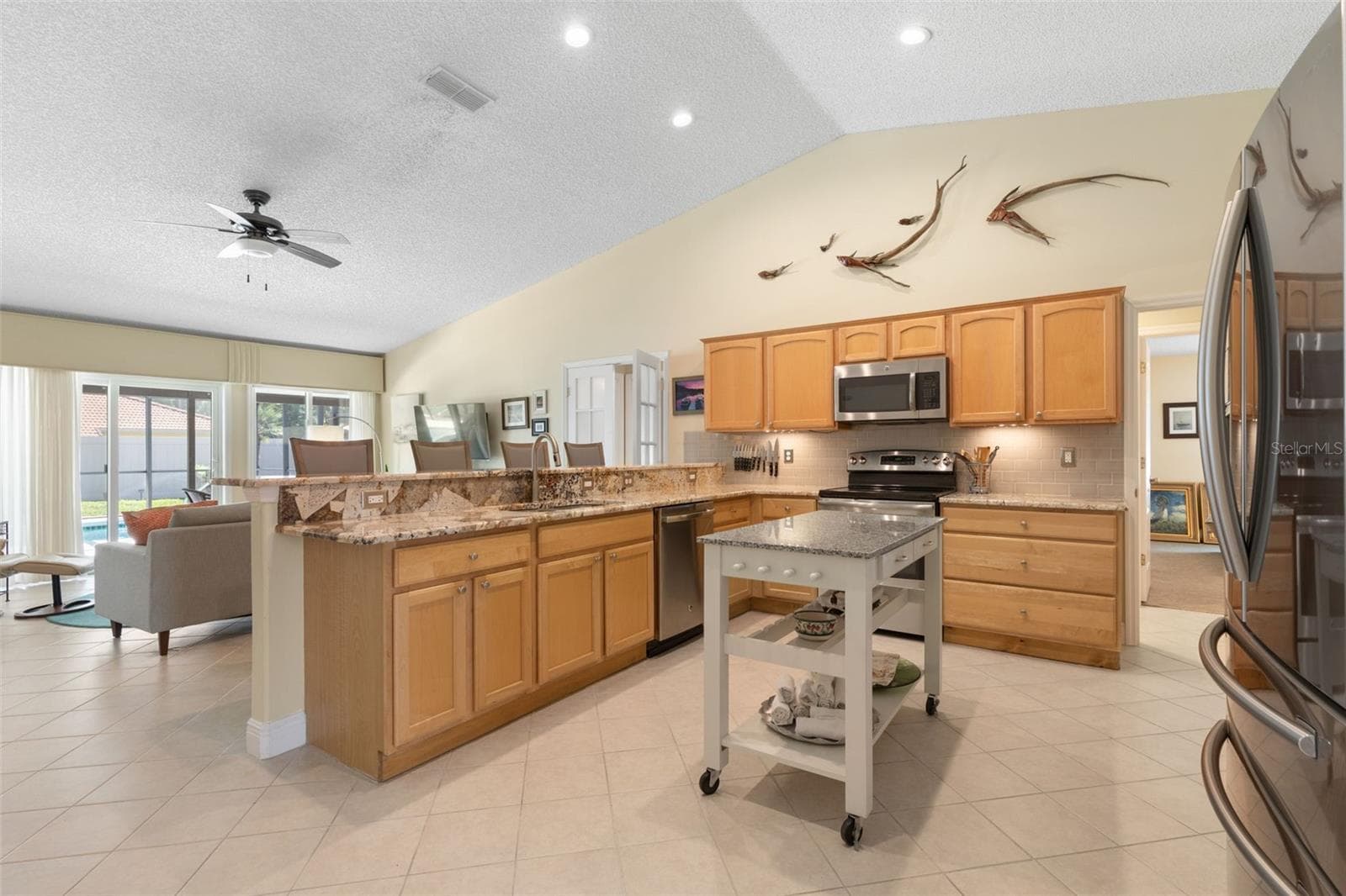 Whether you're preparing a quick breakfast or hosting friends, this kitchen keeps you connected to the conversation! The breakfast bar overlooks the living area, creating a wonderful setting for casual meals and effortless entertaining. - 19 EDGELY LN, PALM COAST