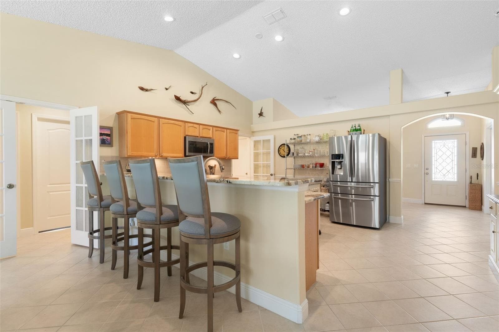 The extended granite breakfast bar offers seating for four, creating a stylish alternative to traditional dining with plenty of counter space for everything from a leisurely brunch to an evening appetizer spread. - 19 EDGELY LN, PALM COAST