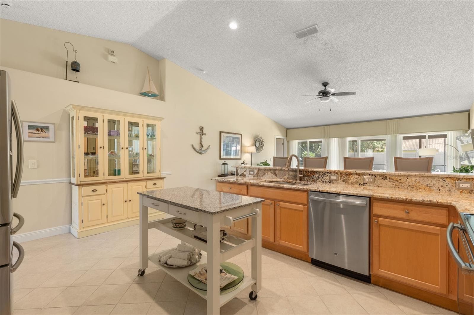A clever touch of flexibility! The movable center island adds extra workspace when needed, while the kitchen’s generous floor space allows you to arrange it to suit your cooking style and daily routine. - 19 EDGELY LN, PALM COAST