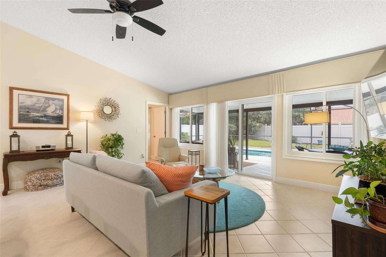 Just a few steps from the sofa, the sparkling pool beckons! Expansive windows and sliding glass doors bring the Florida sunshine indoors, making it easy to slip outside for a refreshing swim whenever the mood strikes. - 19 EDGELY LN, PALM COAST