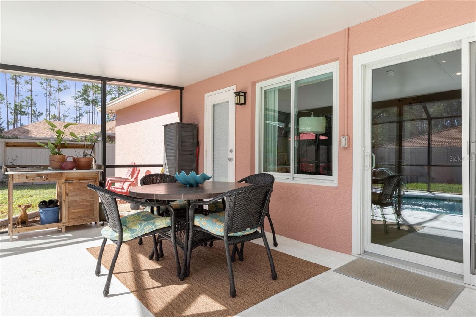 The covered patio offers a shady escape from the Florida sun, with convenient access to the screened pool just steps away. Whether enjoying the outdoors or taking a refreshing dip, relaxation is always within reach! - 19 EDGELY LN, PALM COAST