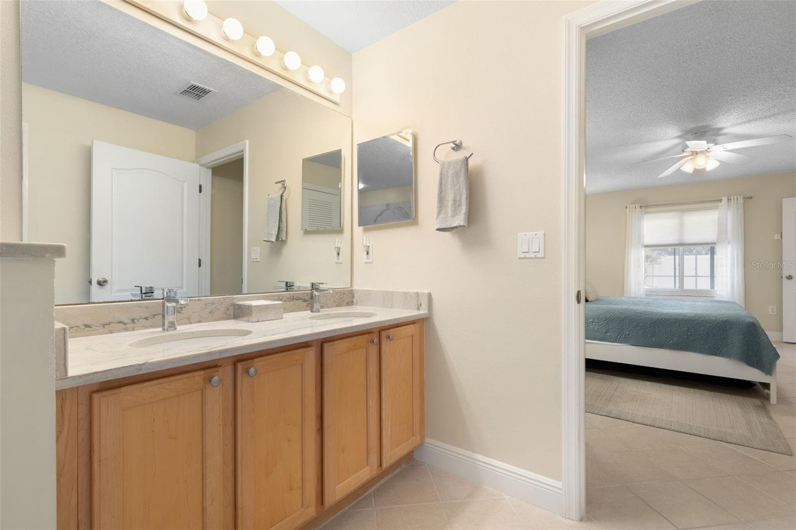 Two sinks, one happy couple! The primary ensuite's spacious dual vanity gives everyone their own space to get ready, making busy mornings a little easier and sharing a bathroom a lot more enjoyable! - 19 EDGELY LN, PALM COAST