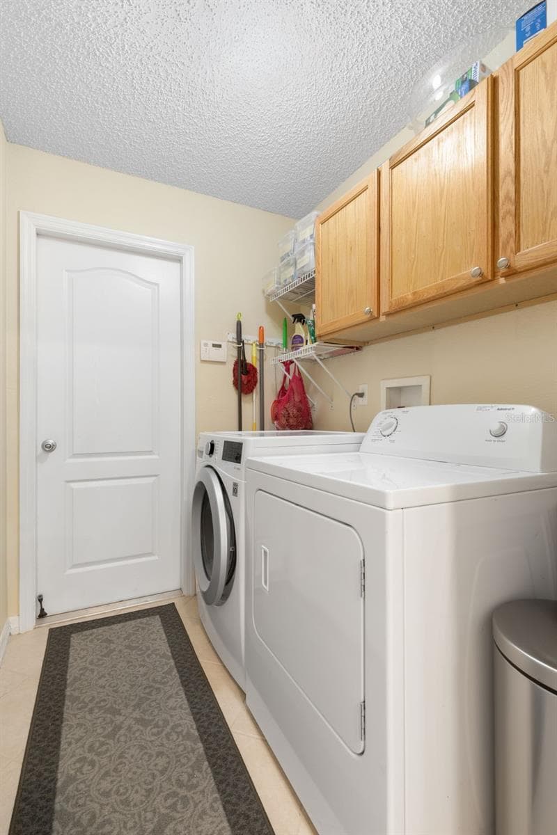 Even laundry day gets a little easier! This dedicated laundry room keeps everything organized with a full-size washer and dryer, overhead cabinetry, and additional shelving for everyday essentials. - 19 EDGELY LN, PALM COAST