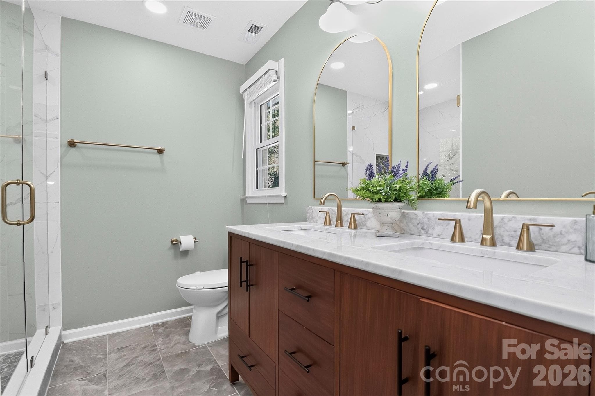 Newly remodeled with dual vanity, luxurious Carrara marble countertop. - 9915 Ridgemore Drive, Charlotte