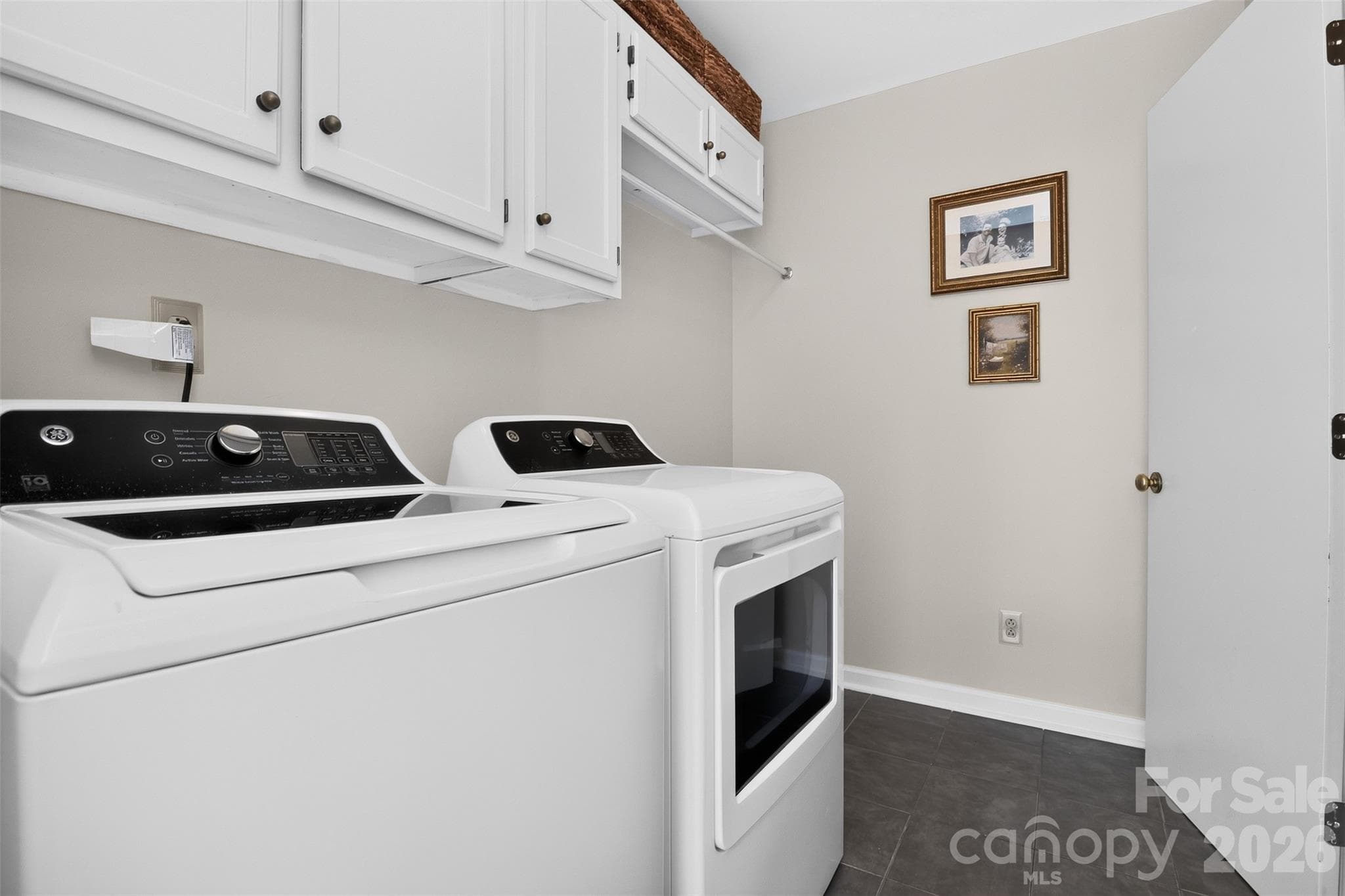 Handy Laundry room with storage nook. - 9915 Ridgemore Drive, Charlotte