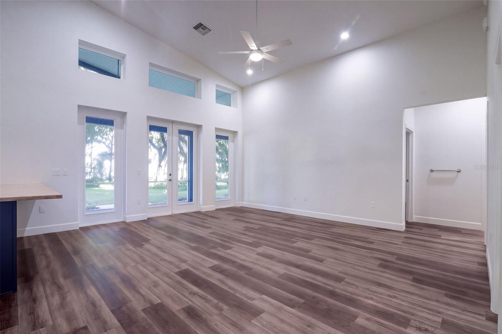 Great room with French doors to the screened porch and views to Lake Harris - 4410 CORLEY ISLAND RD, LEESBURG