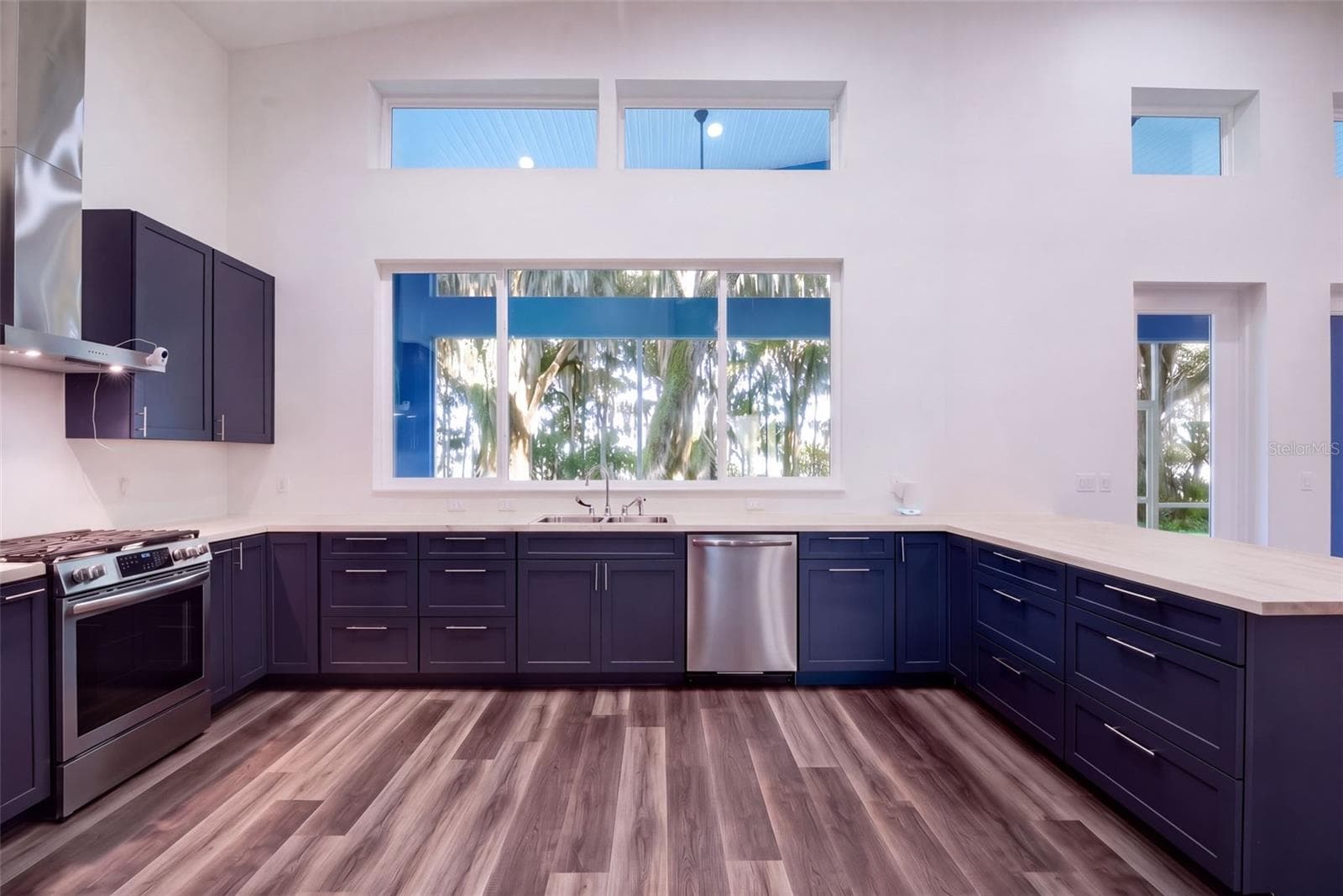 U-shaped kitchen: navy soft-close shaker cabinets and butcher block counters - 4410 CORLEY ISLAND RD, LEESBURG
