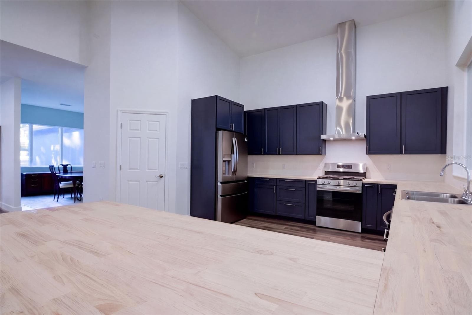 Butcher block breakfast bar with seating for casual meals - 4410 CORLEY ISLAND RD, LEESBURG