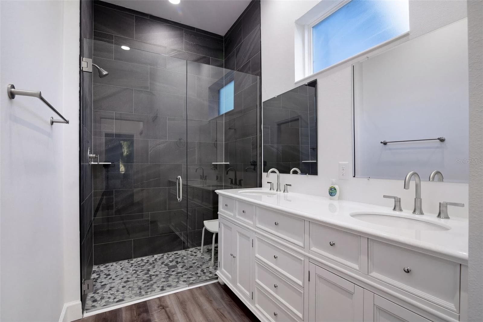 Primary bath: dual sinks, glass walk-in shower, and private water closet - 4410 CORLEY ISLAND RD, LEESBURG