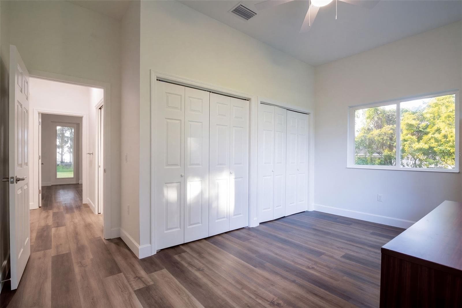 Third bedroom with double closets and a view of the oaks - 4410 CORLEY ISLAND RD, LEESBURG