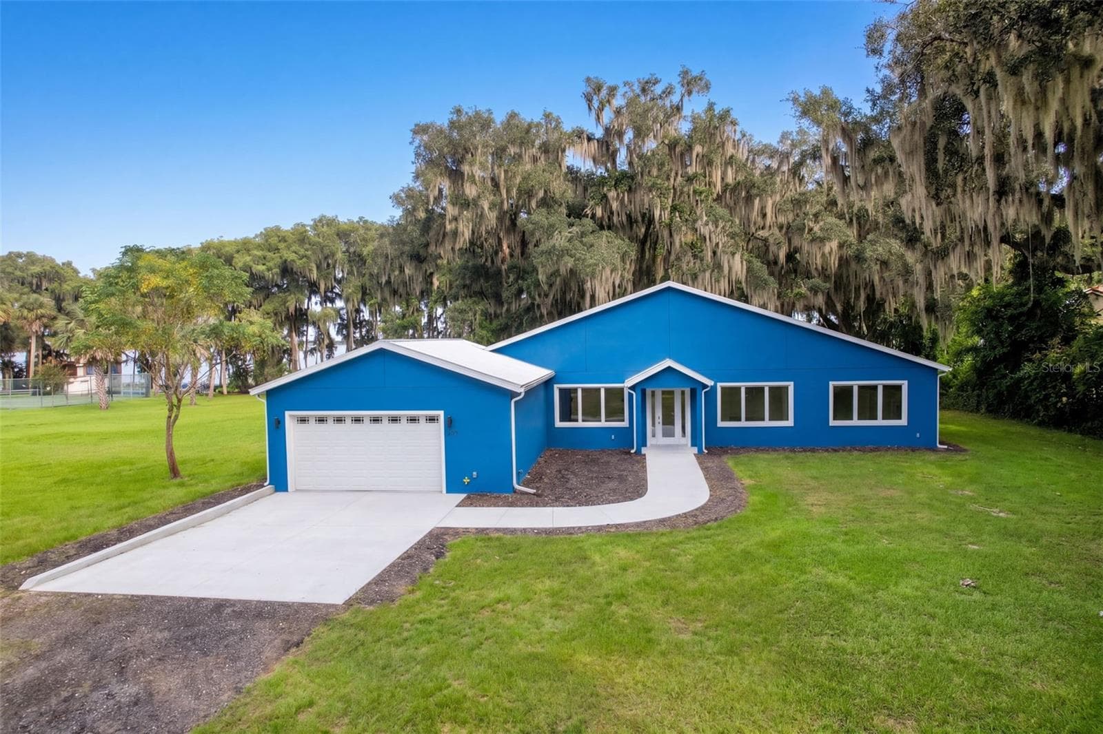 Front of home with 2-car attached garage and wide driveway - 4410 CORLEY ISLAND RD, LEESBURG
