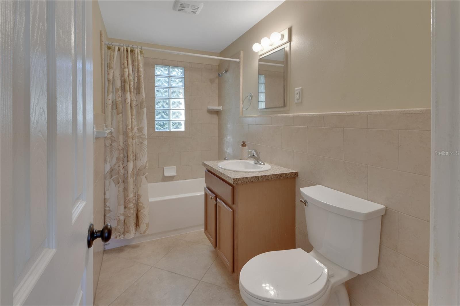 Spacious bathroom with tiled walls and new toilet - 147 LUCERNE DR, DEBARY