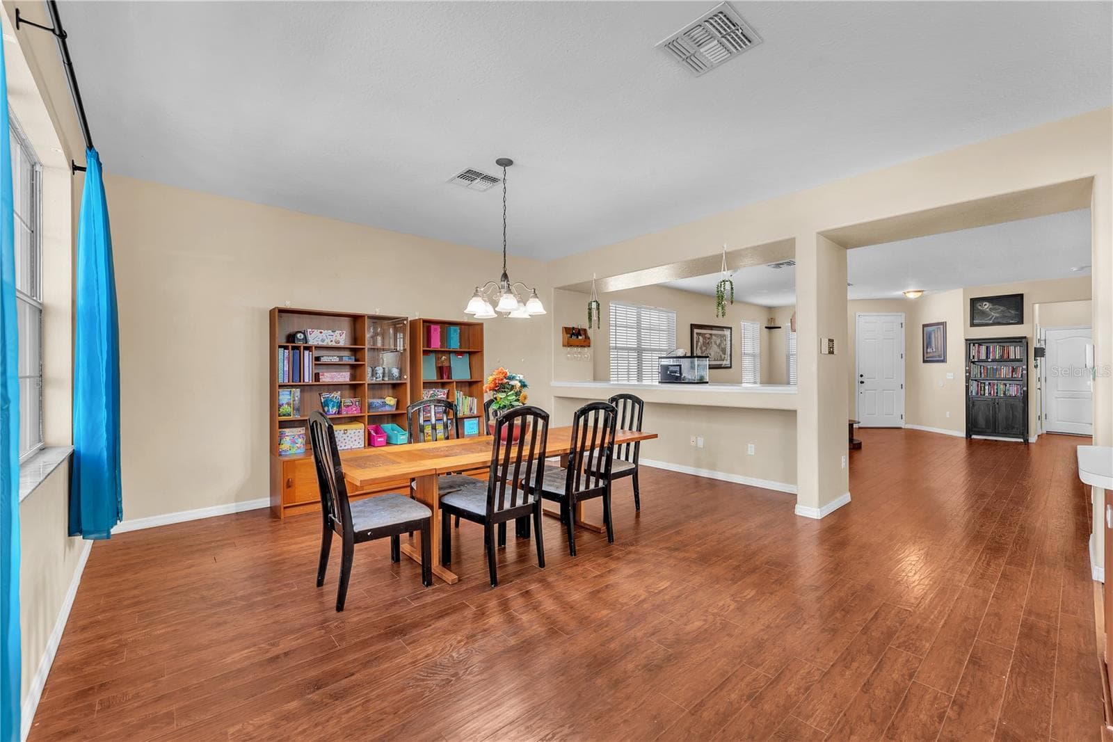 Separate dining and living areas with open sight lines that create a connected, inviting feel. - 18801 SUNTERRA DR, LAND O LAKES