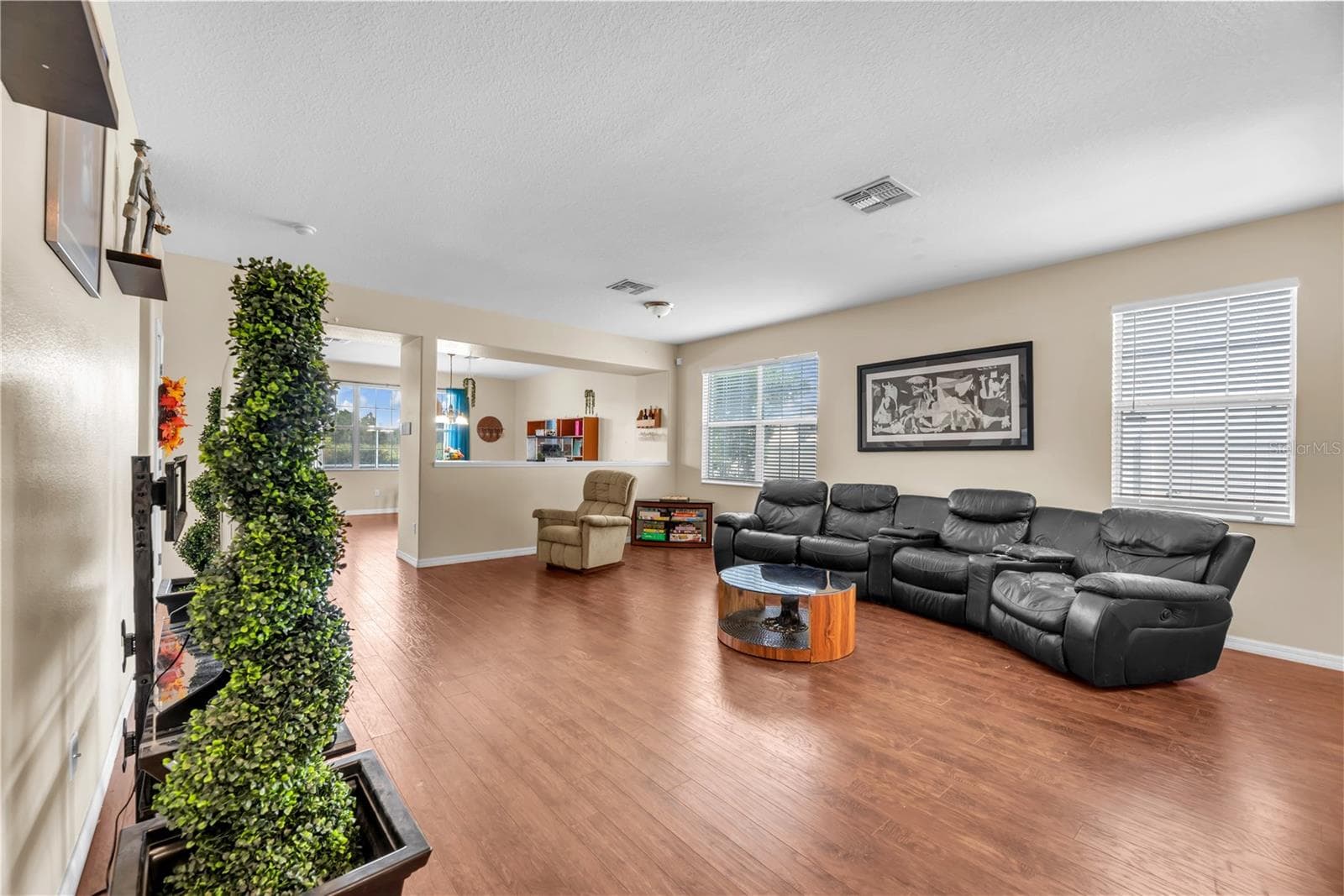 Durable wood-grain laminate flooring throughout the main living areas. - 18801 SUNTERRA DR, LAND O LAKES