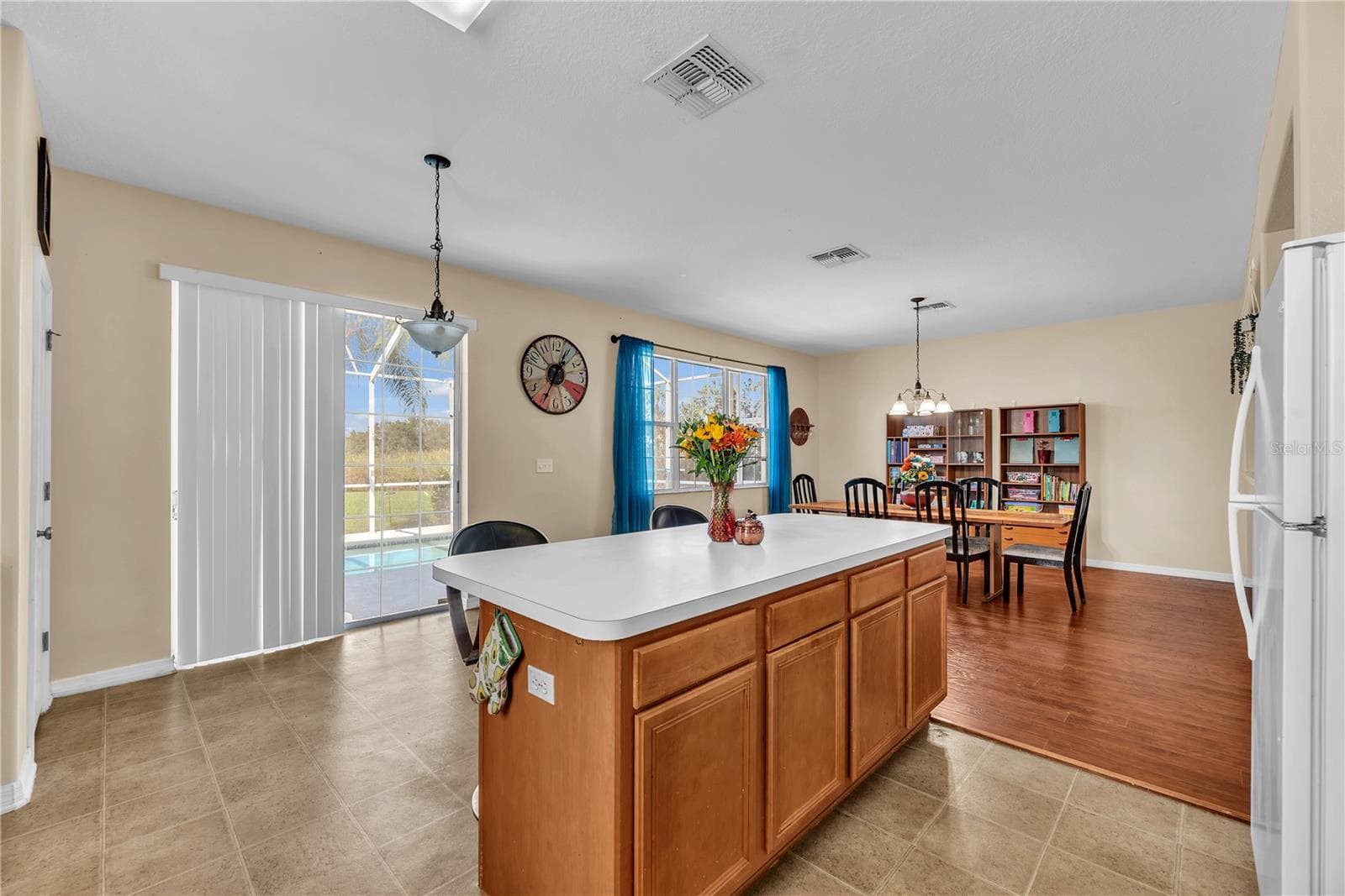 There is room for a casual dining table overlooking the backyard oasis. - 18801 SUNTERRA DR, LAND O LAKES