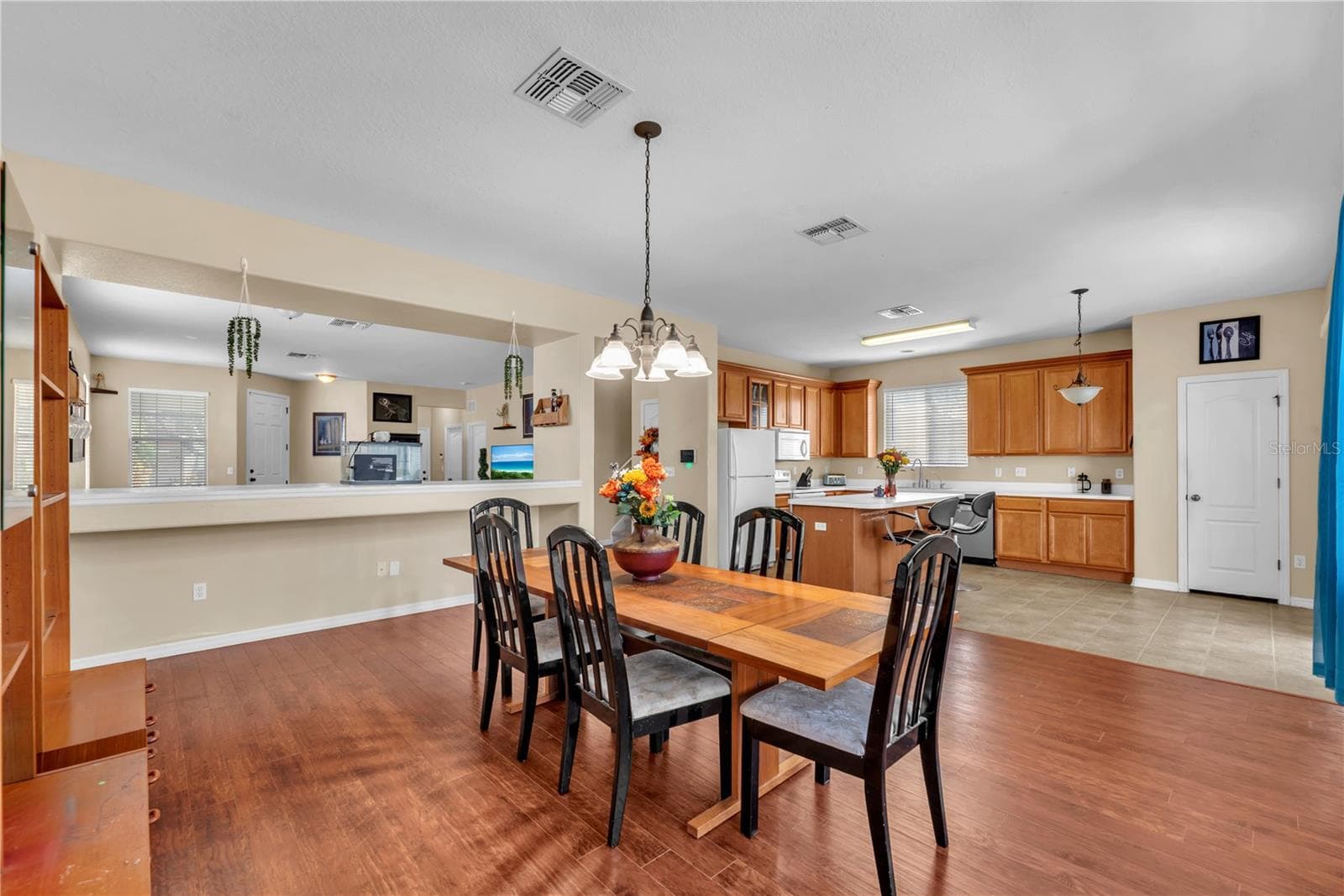 A spacious dining room sits just off the kitchen, with open sight lines into the living room that keep conversations flowing and create a warm, connected space for entertaining. - 18801 SUNTERRA DR, LAND O LAKES