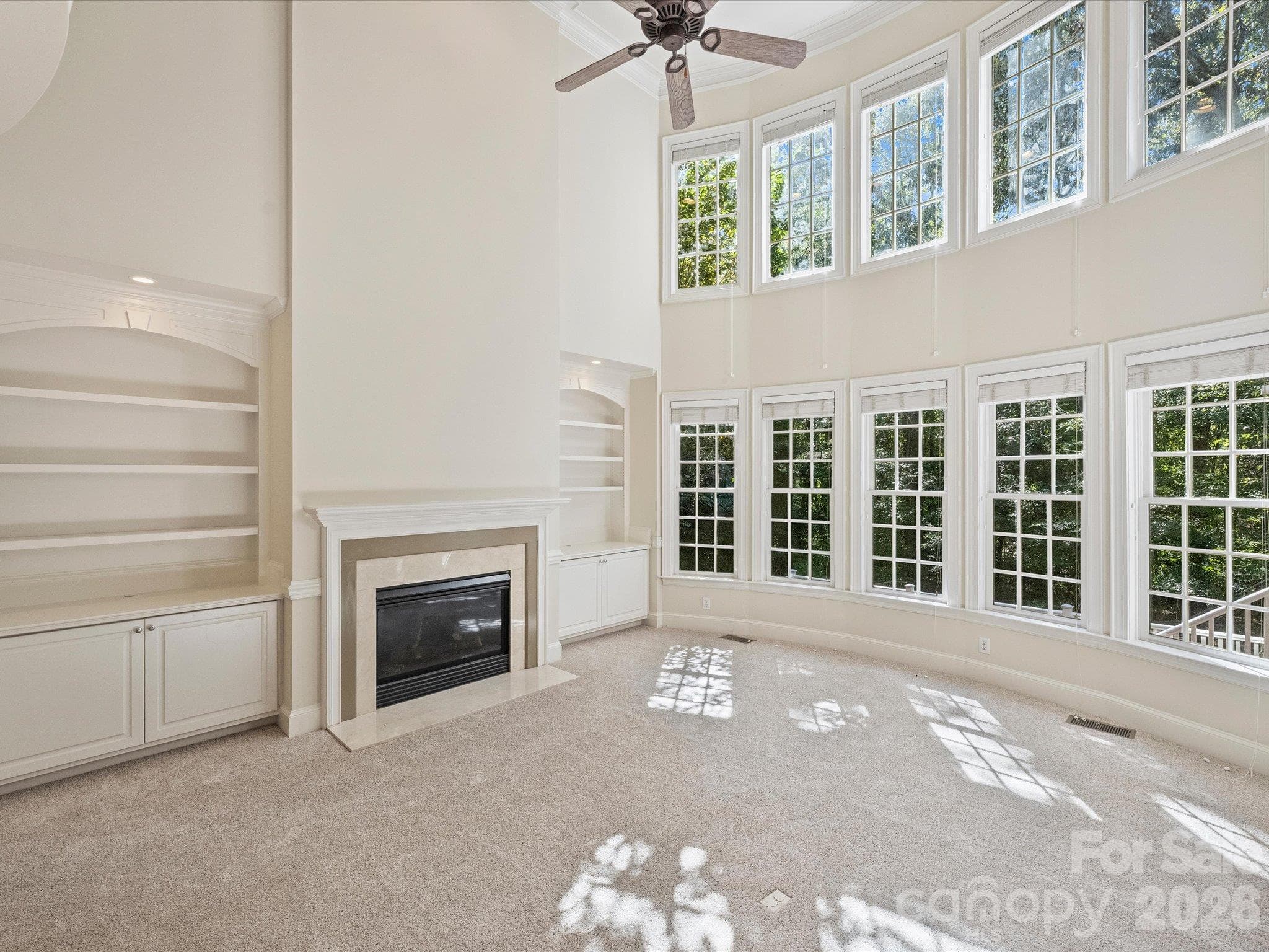 Beautiful built-ins surround fireplace in great room - 7705 Stonehaven Drive, Waxhaw