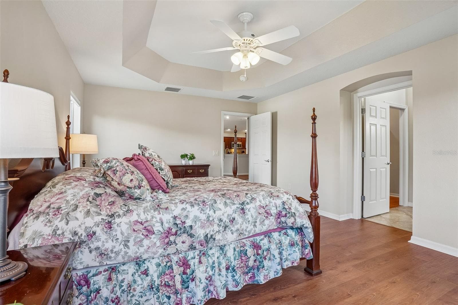 Primary Bedroom with Tray Ceiling & Water View - 494 ARBELLA LOOP, THE VILLAGES