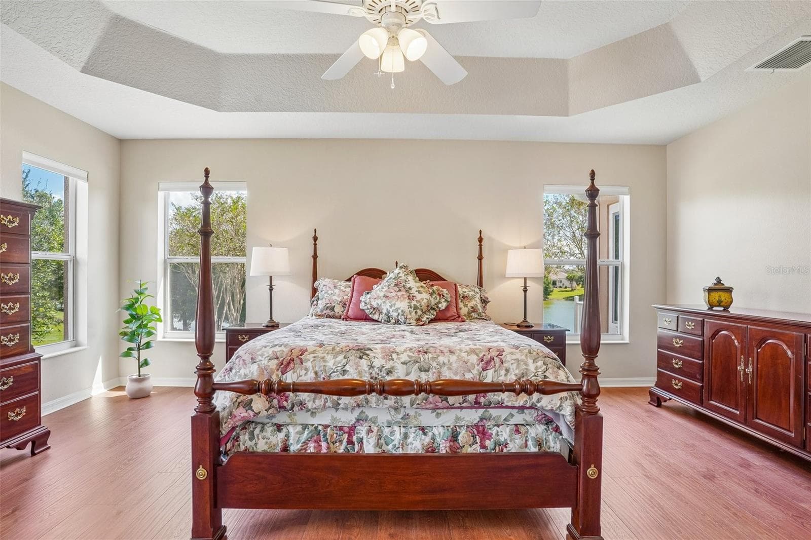 Primary Bedroom with Tray Ceiling & Water View - 494 ARBELLA LOOP, THE VILLAGES