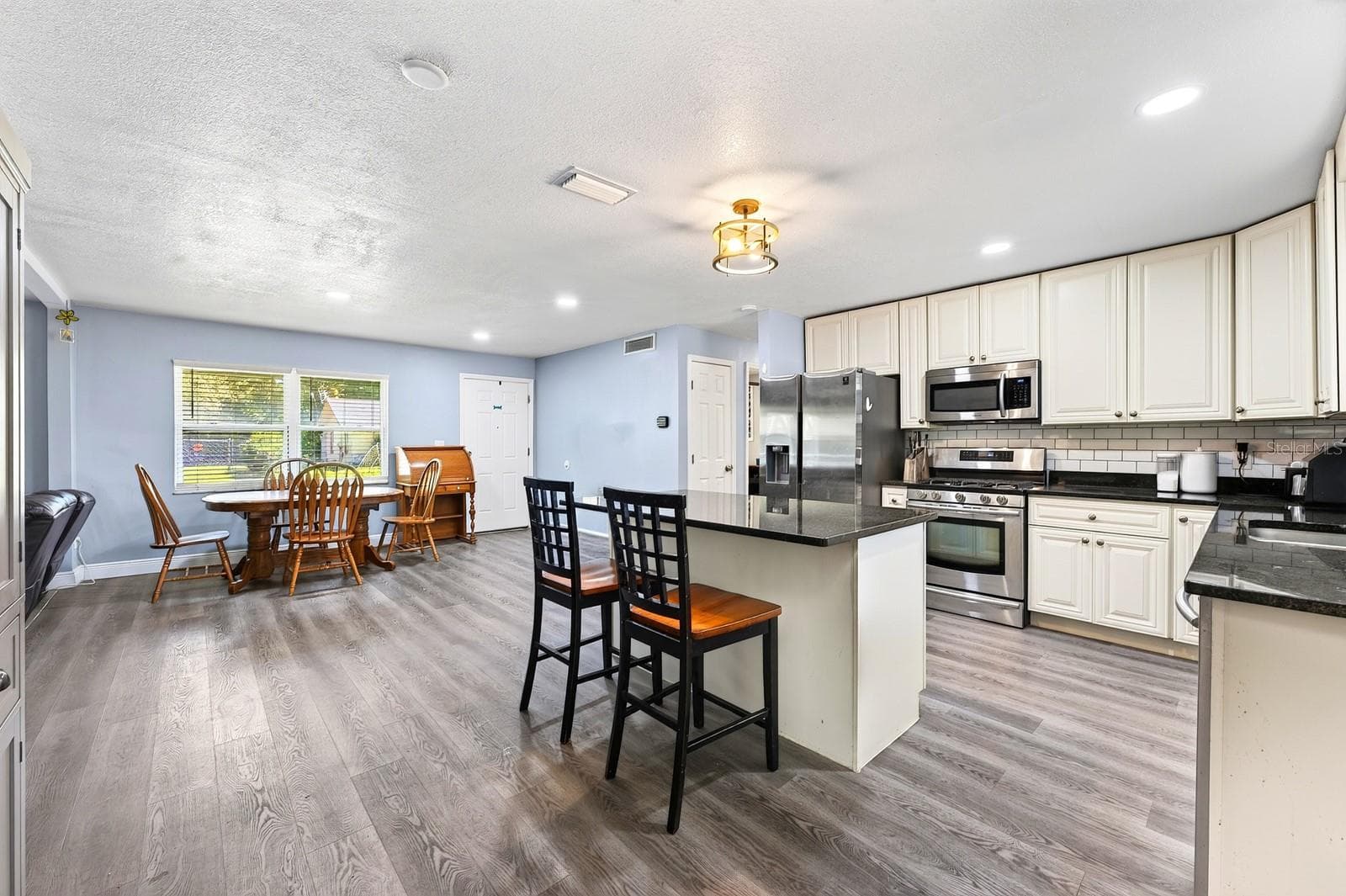 Inside, BEAUTIFUL LVP FLOORING and NEW LEVELOR BLINDS throughout, create a fresh, cohesive look. - 1444 KENNY CT, WINTER GARDEN
