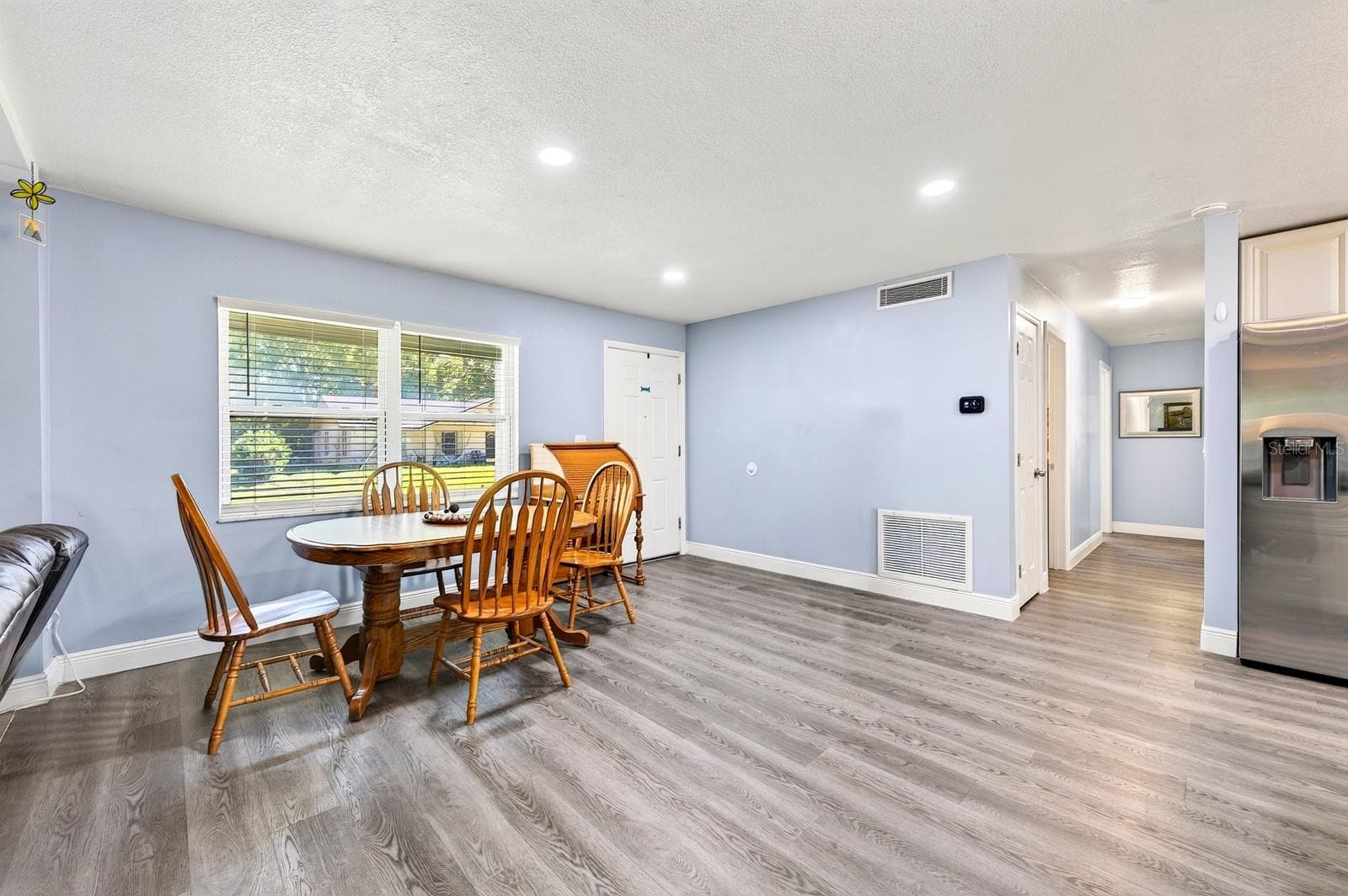 NATURAL LIGHT fills the space, enhancing the bright and airy feel in the Dining Room. - 1444 KENNY CT, WINTER GARDEN