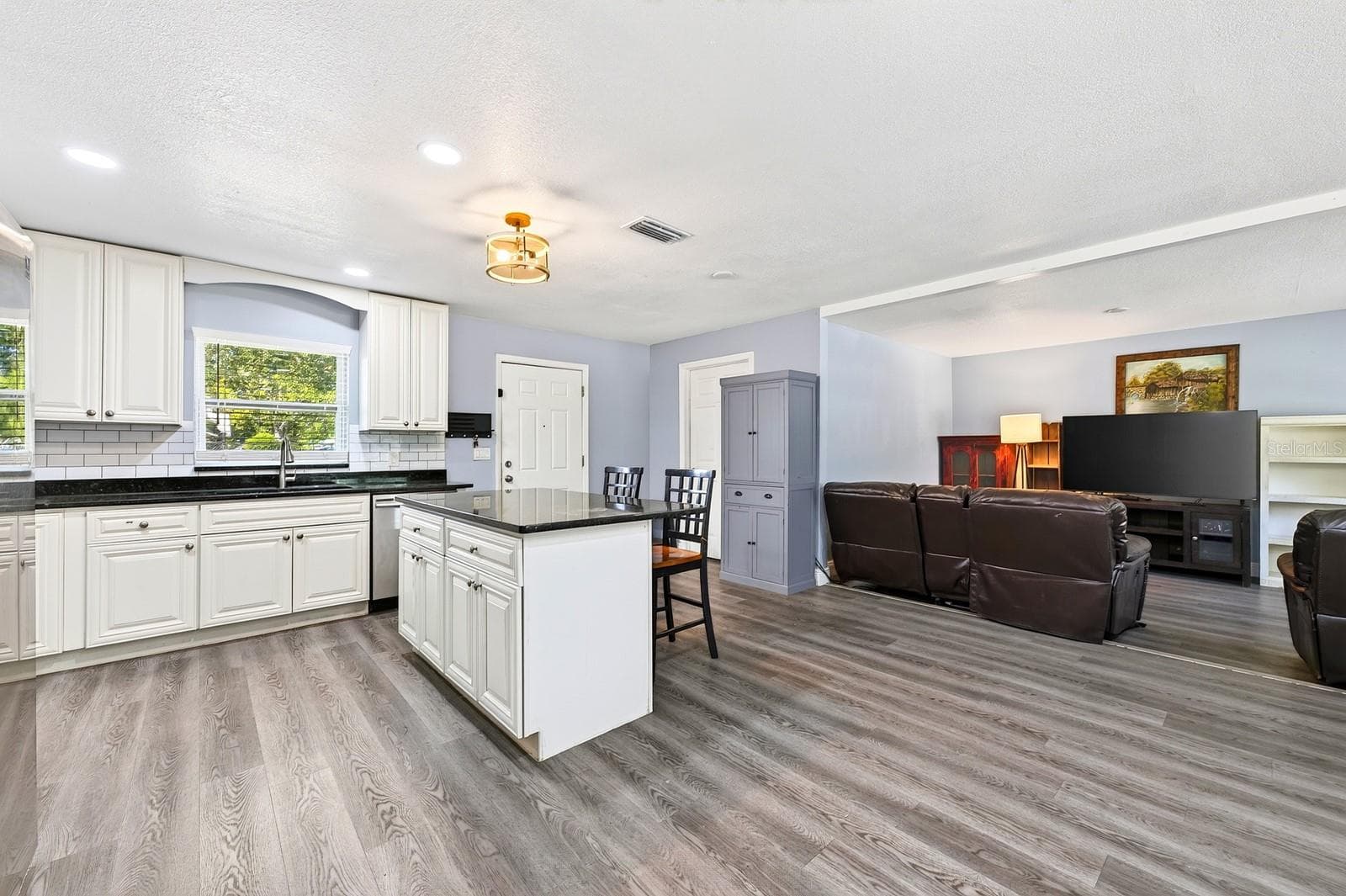 The OPEN FLOOR PLAN allows the Living Room, Dining Room and Kitchen to flow together seamlessly. - 1444 KENNY CT, WINTER GARDEN