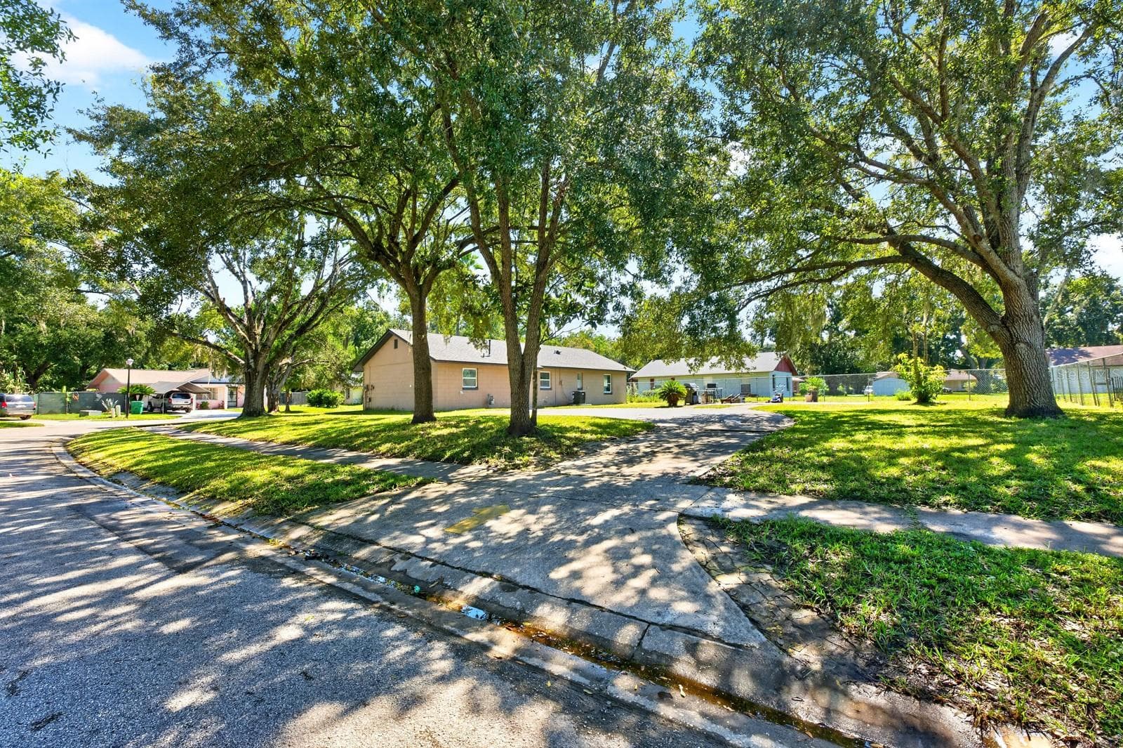 Set on NEARLY A QUARTER ACRE, the property features MATURE SHADE TREES, a large driveway with ample parking and a welcoming setting. - 1444 KENNY CT, WINTER GARDEN