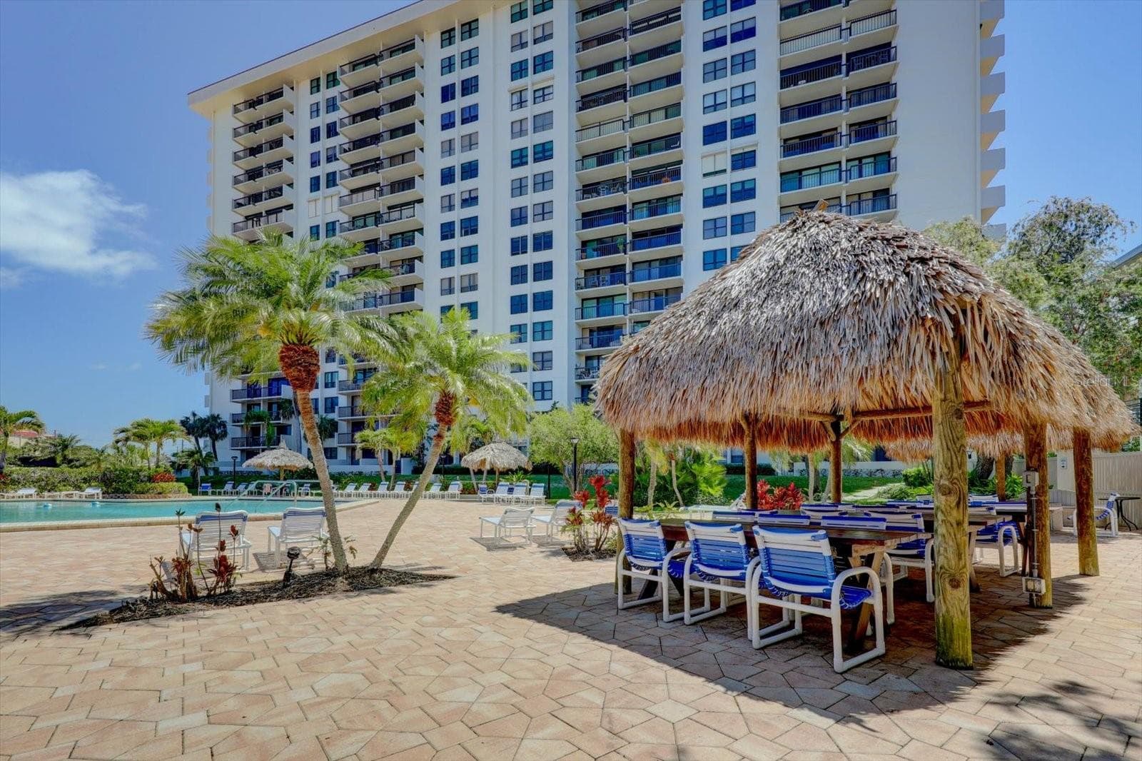 Outdoor tiki hut dining space provides the perfect poolside spot to enjoy a meal in the shade. - 400 ISLAND WAY #904, CLEARWATER BEACH