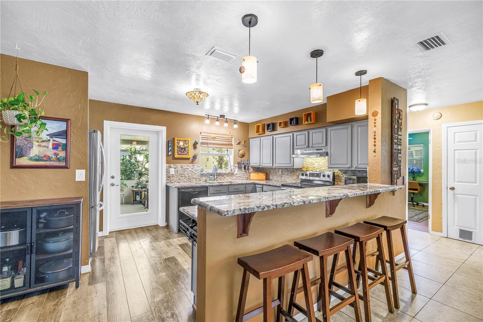 Updated kitchen with granite countertops, dimmable lighting and a glass panel door to access the back yard. - 2573 62ND TER N, ST PETERSBURG