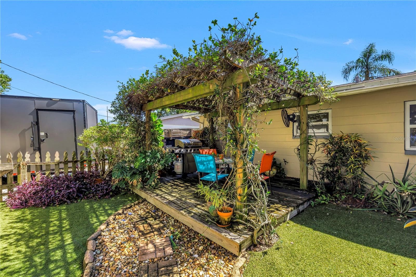 Mature jasmine covers this gazebo, currently a space to grill and dine alfresco. - 2573 62ND TER N, ST PETERSBURG