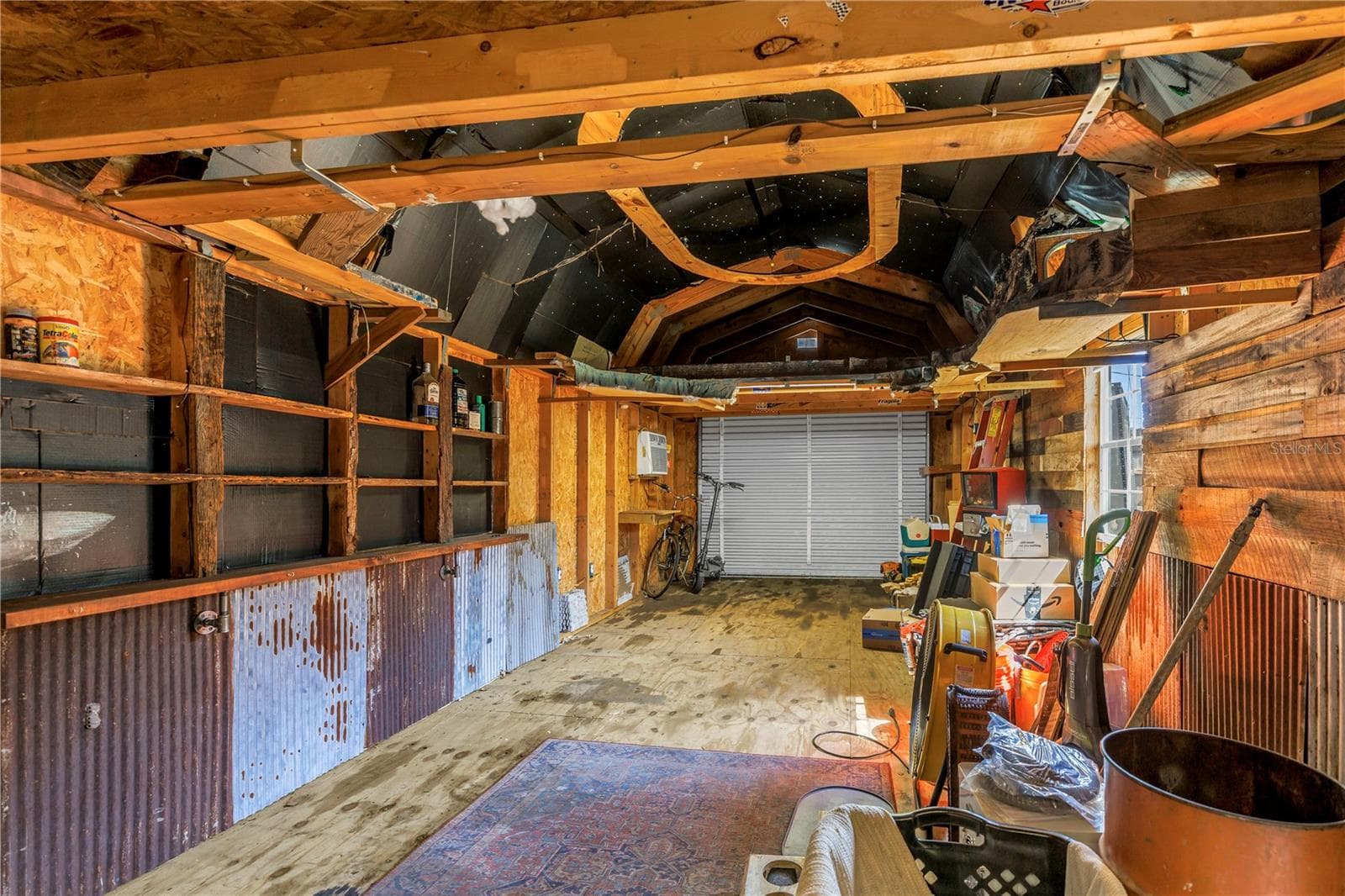 Here's a view inside the 31' long workshop featuring the rollup door accessible from the secondary driveway. - 2573 62ND TER N, ST PETERSBURG