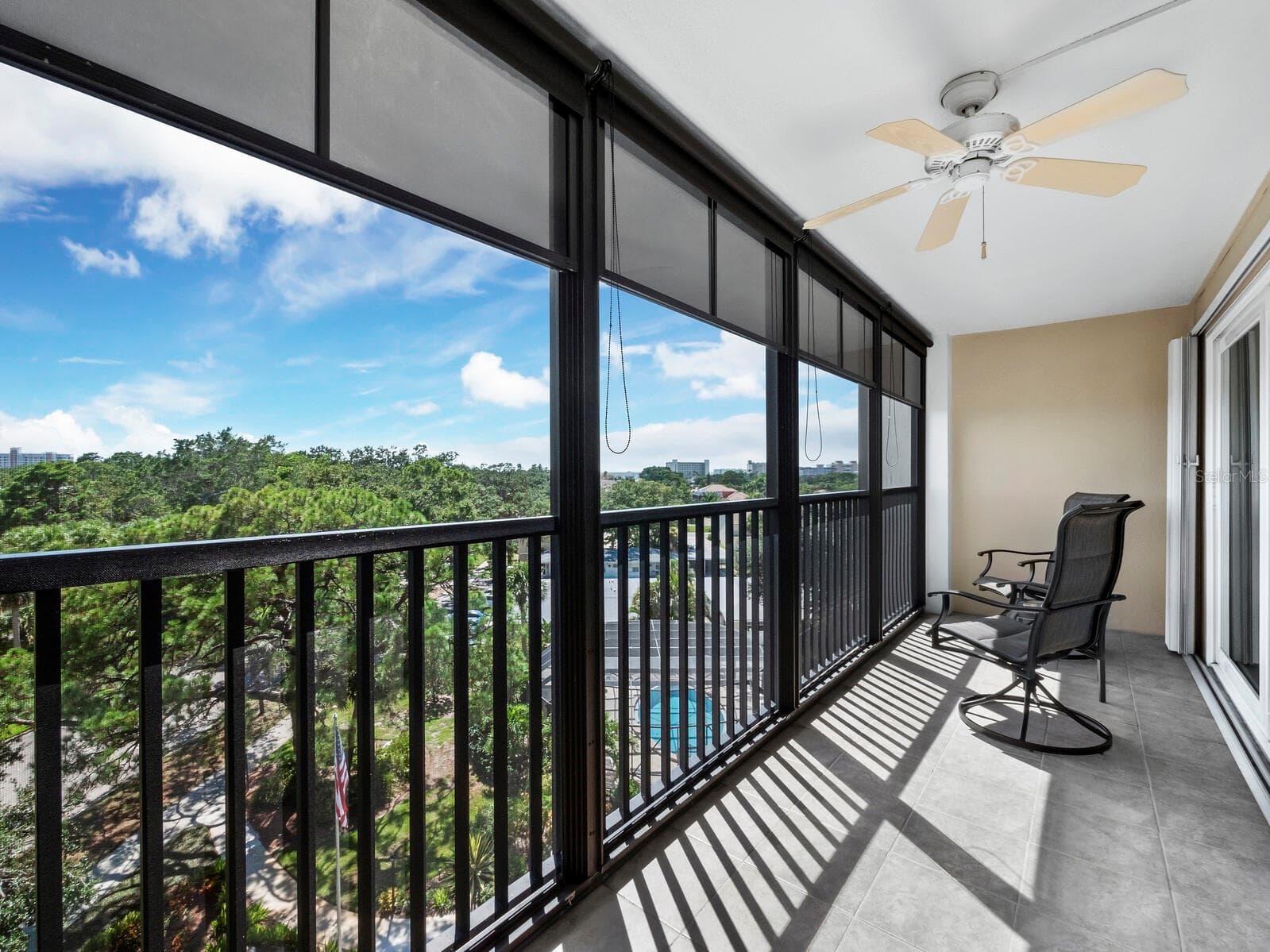 Tile flooring on the lanai, shade screens and easy slide permanent storm shutters in addition to the imact glass sliders for added protection. - 512 W VENICE AVE #607, VENICE
