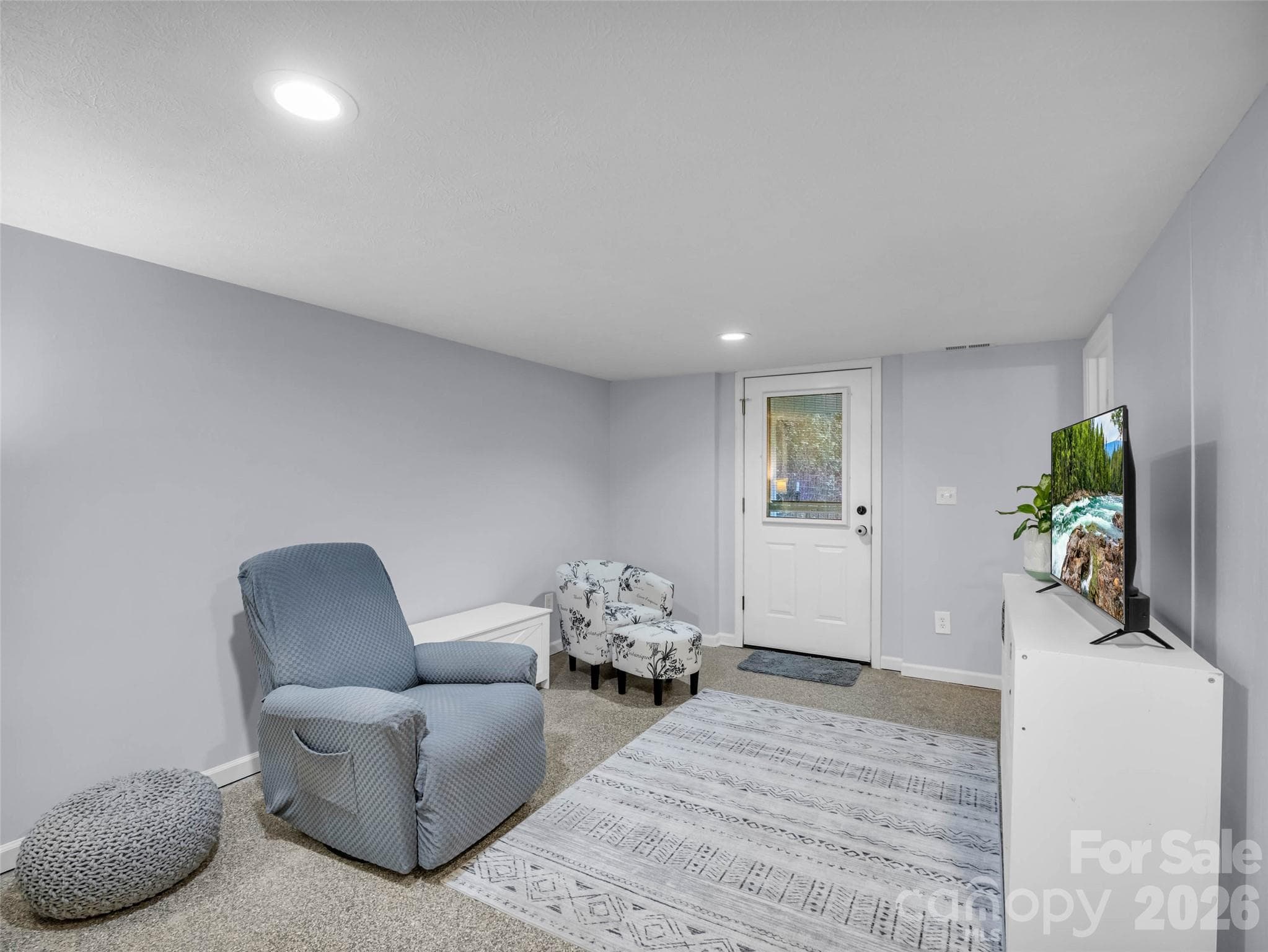 A comfortable second living room with its own exterior access. - 913 Dorothy Street, Hendersonville