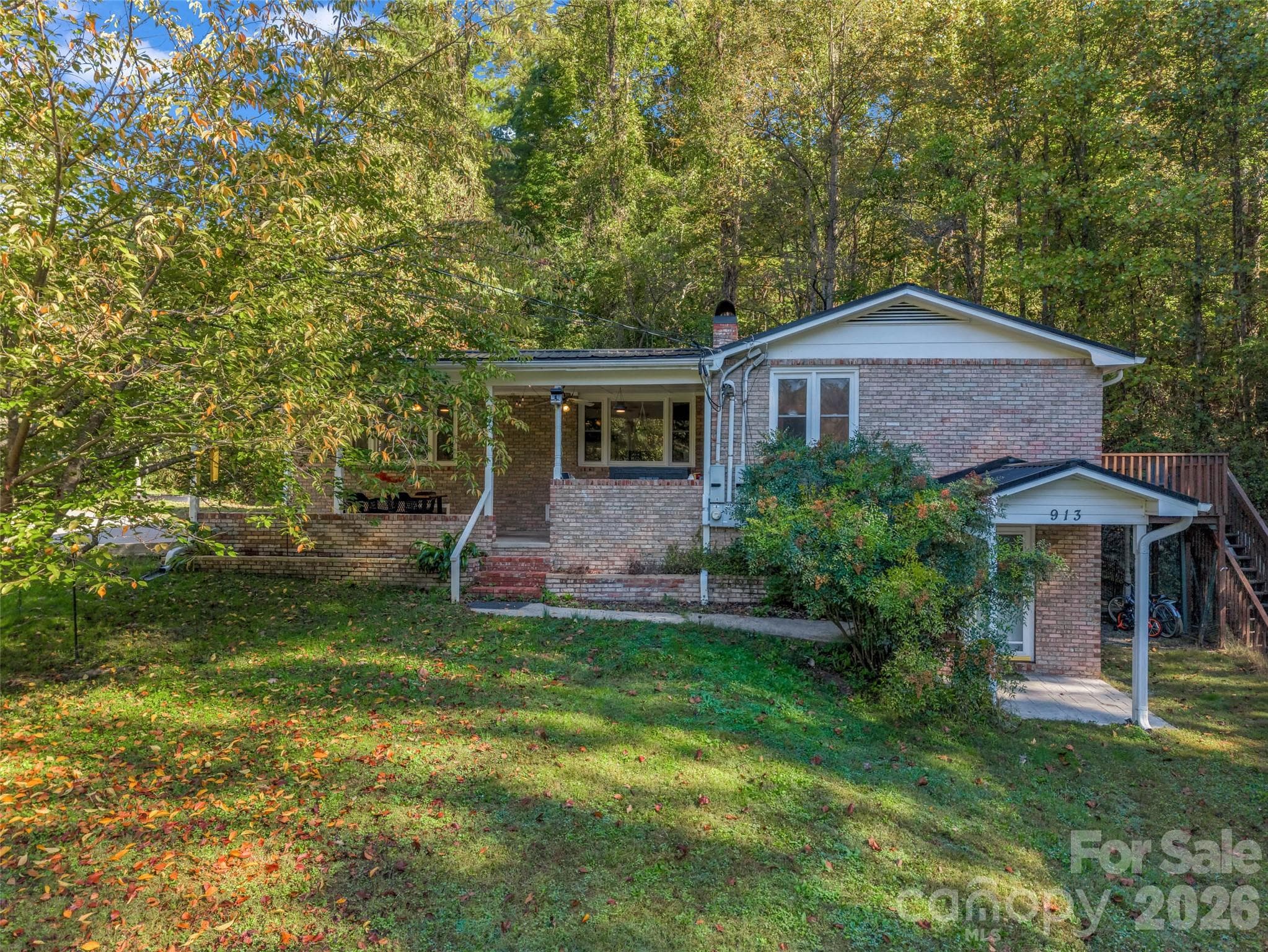 A side view highlights the home's two-level design. - 913 Dorothy Street, Hendersonville