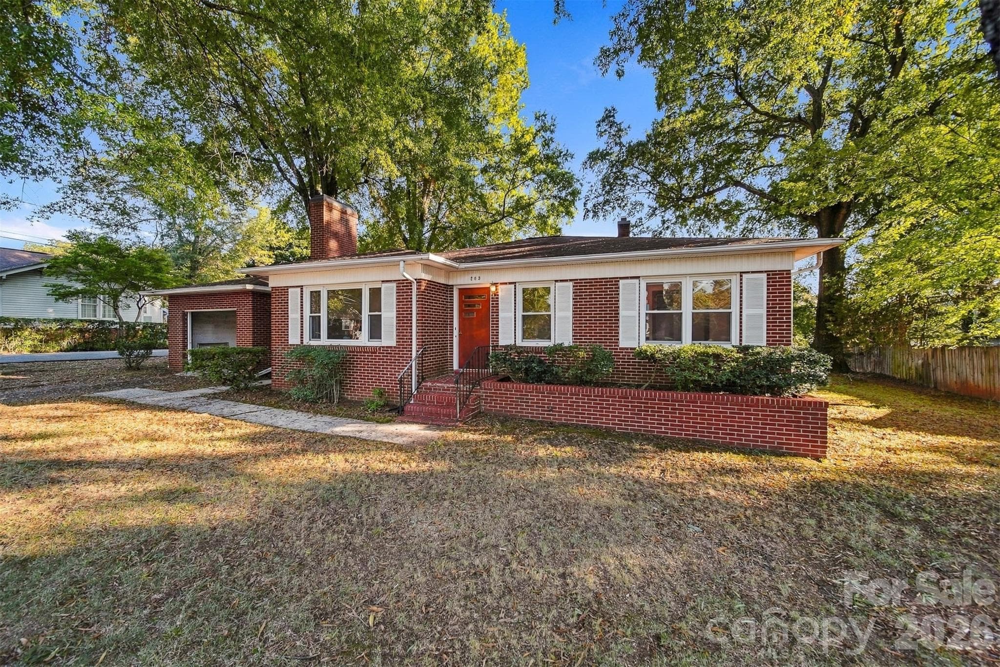 Home features a one car garage attached with a breezeway. - 203 W 21st Street, Newton