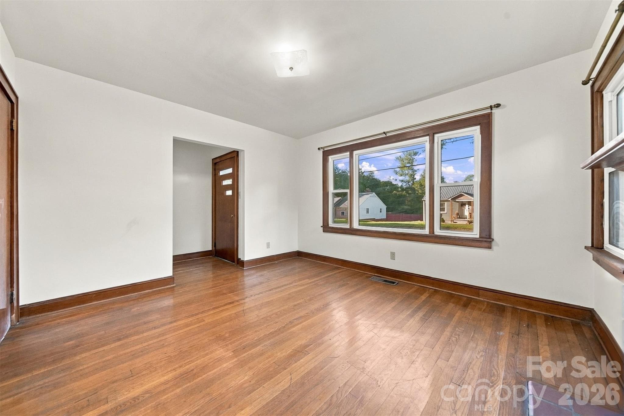 Front entrance with small foyer. Wonderful light flows in from the windows. Hardwood flooring. - 203 W 21st Street, Newton
