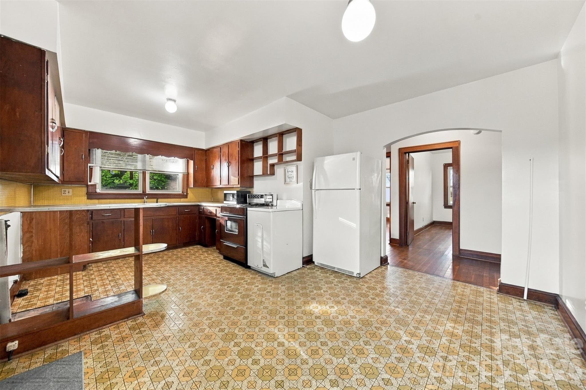Electric range and refrigerator will remain as well as the counter top microwave. - 203 W 21st Street, Newton