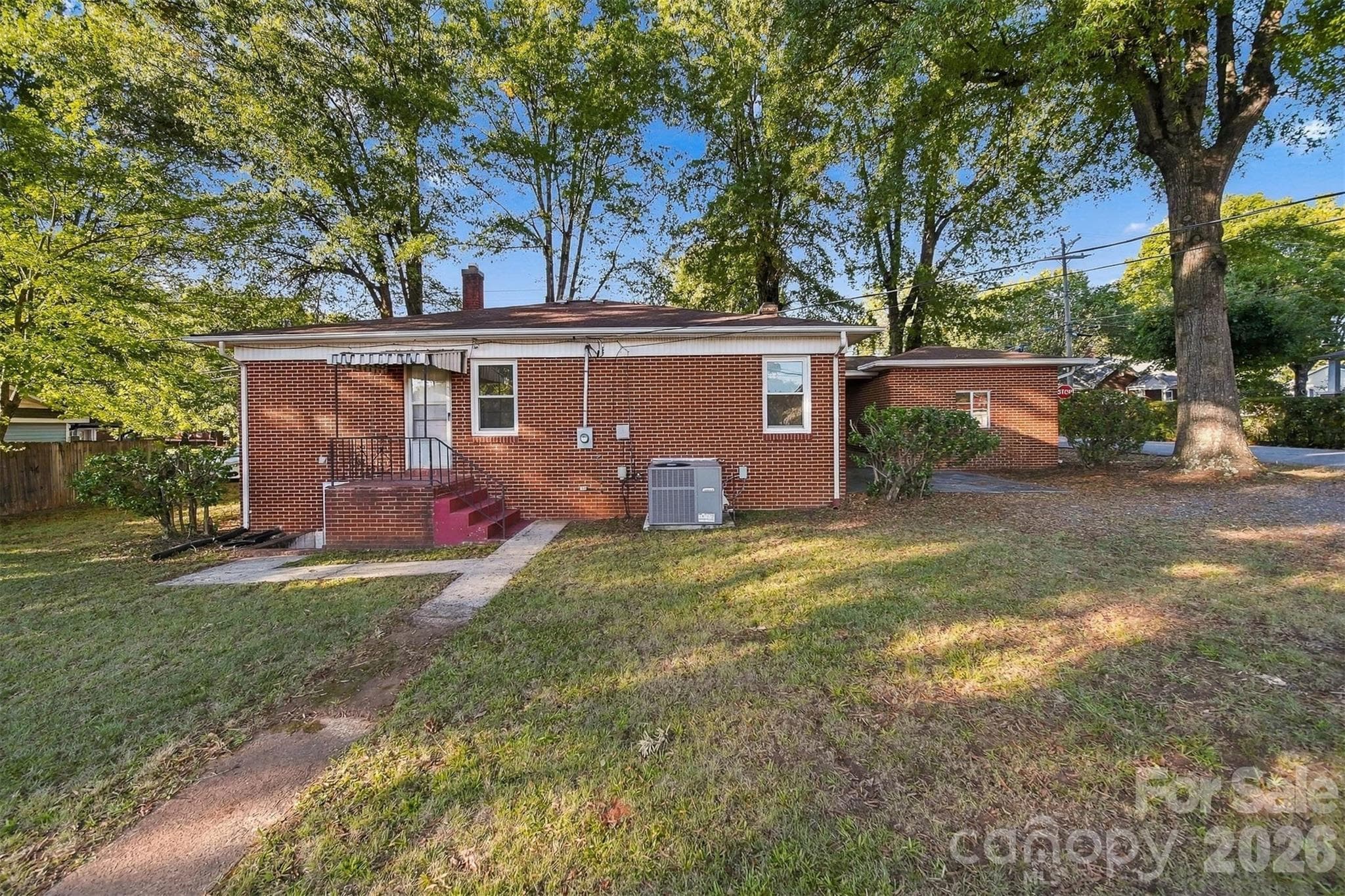 Back of home shows the covered porch. - 203 W 21st Street, Newton