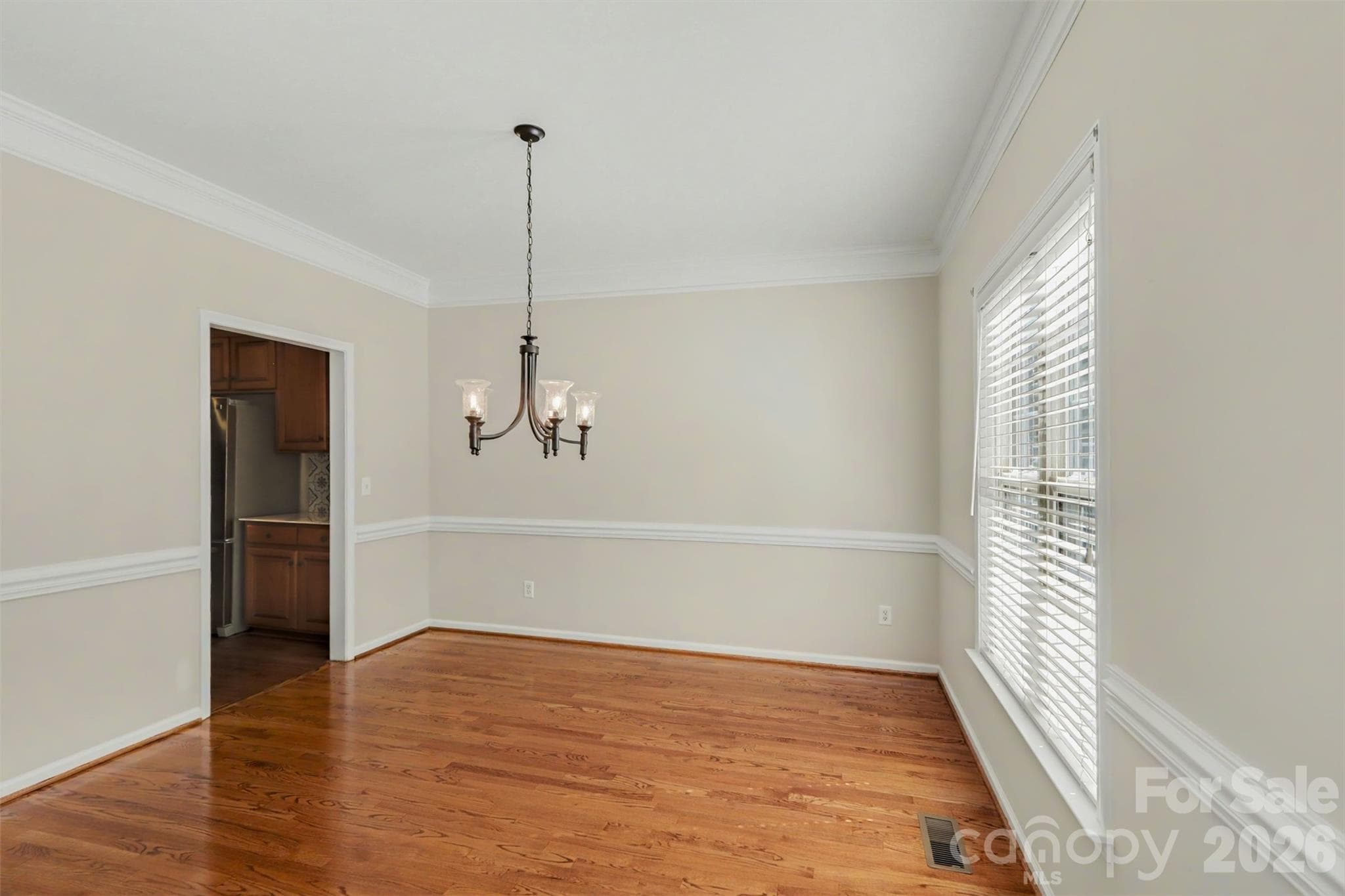 Dining Area off Foyer, features Crown Molding, Chair Railing, & Hardwoods - 17028 Hampton Trace Road, Huntersville