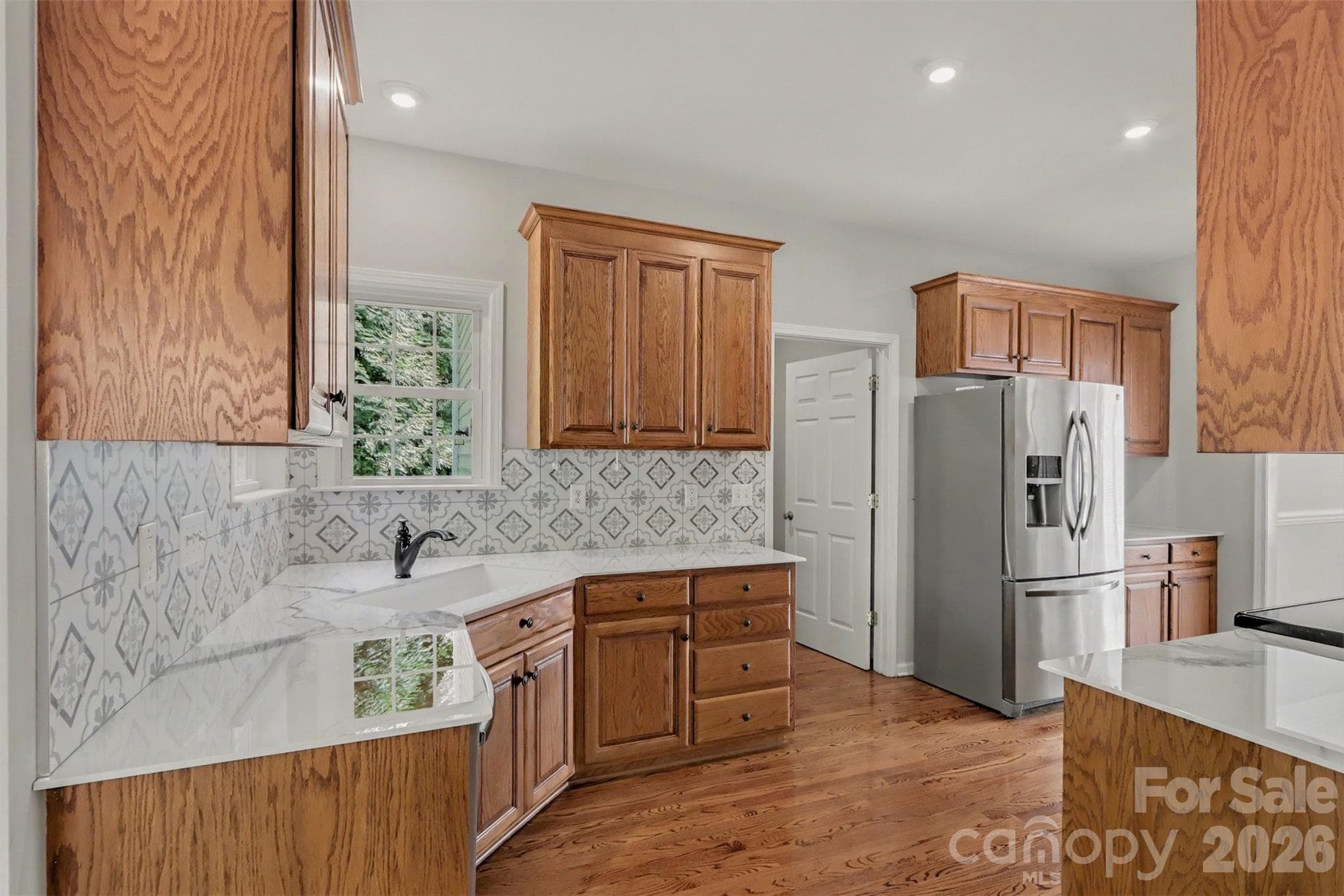 Cabinets, backsplash, upgraded countertops, SS refrigerator - "Move-In Ready" - 17028 Hampton Trace Road, Huntersville
