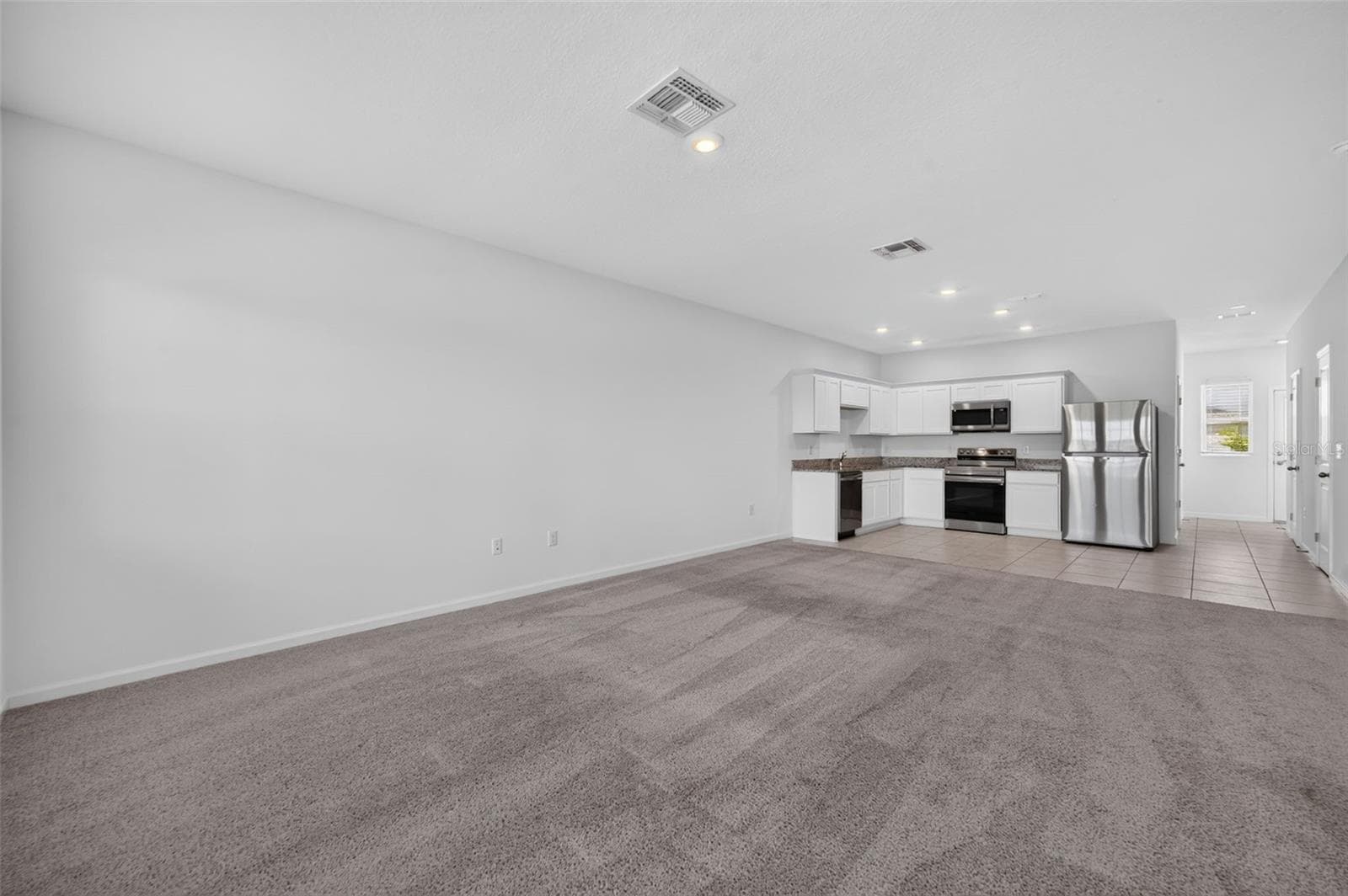 Living room and kitchen view as seen from Front door - 381 GRAND PINE LN, ST CLOUD
