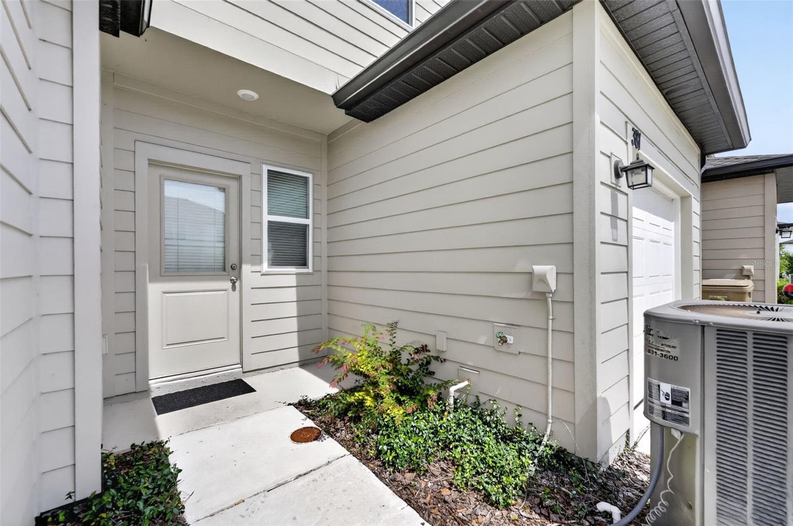 Garage Drive up and Rear entry of townhome - 381 GRAND PINE LN, ST CLOUD